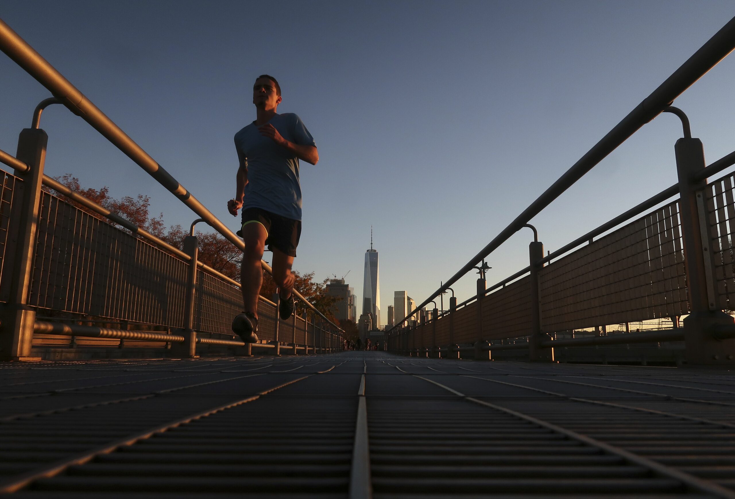 a man runs in the hudson river park at sunset in new york city 624813952 583659073df78c6f6a5efd57 scaled