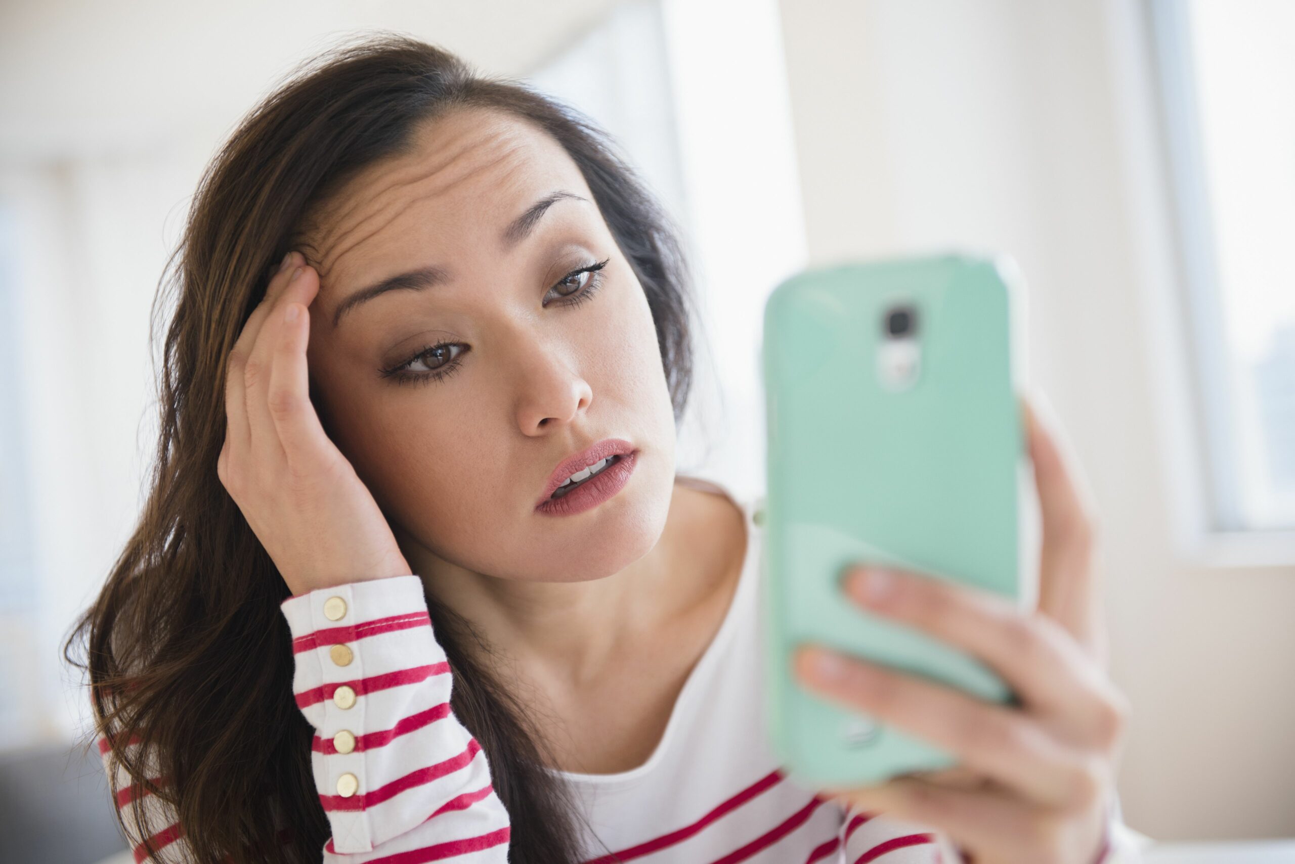stressed woman using cell phone 649660615 5c5355e34cedfd0001efd4cb scaled