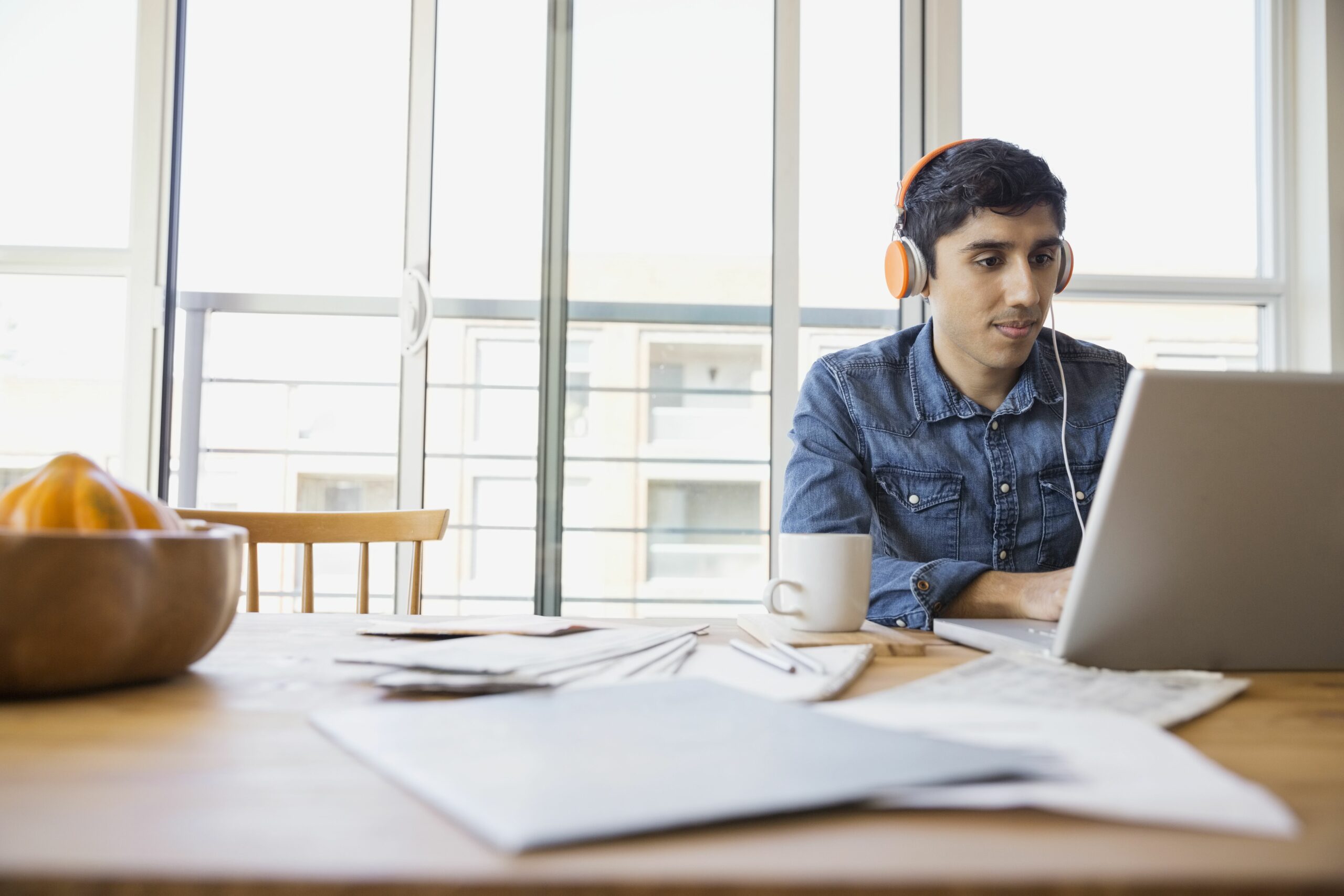 man in headphones using laptop at table 522795487 5b86f7b946e0fb005028ee99 scaled