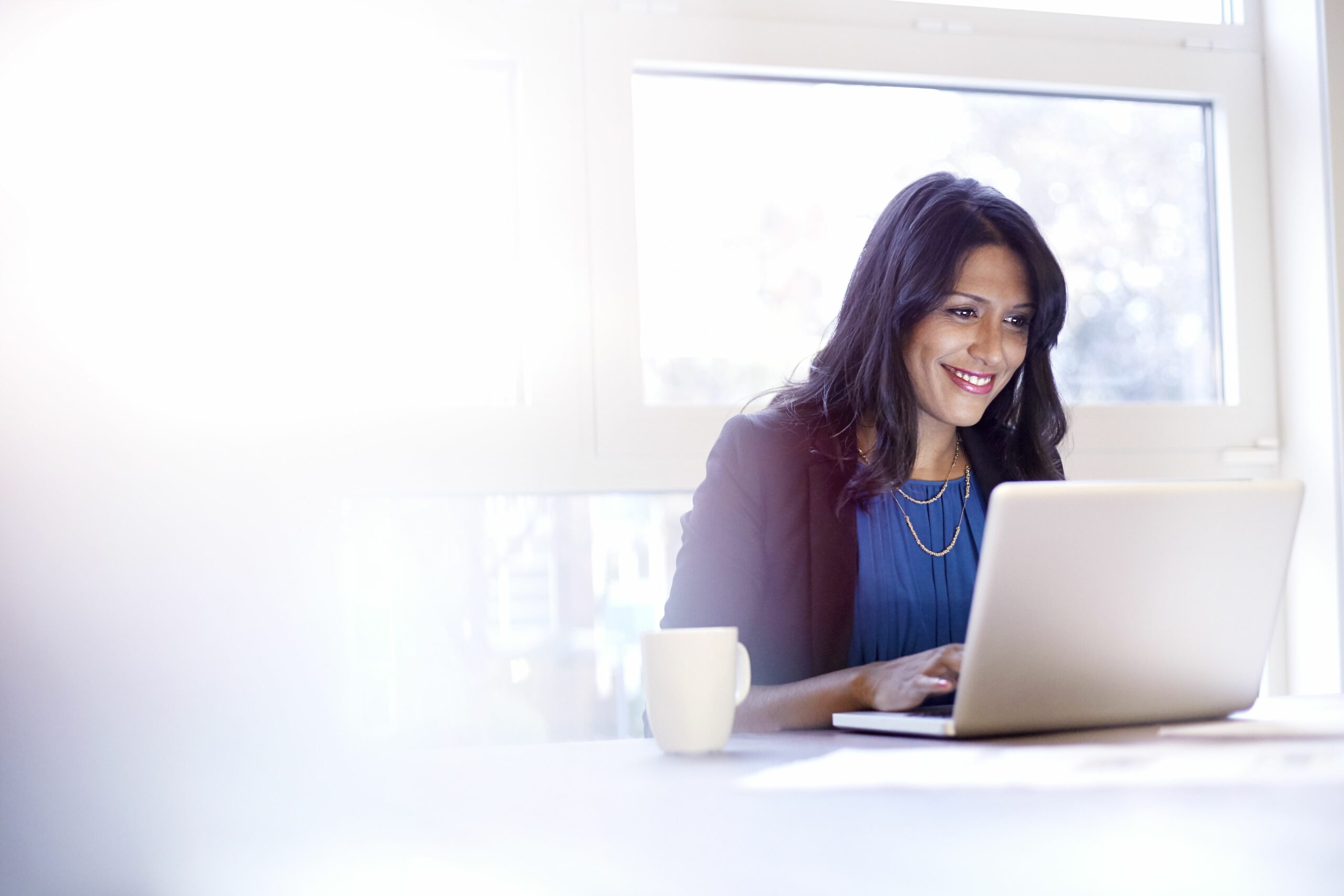 young business woman working on a laptop 528913607 5c16c611c9e77c00010b629b scaled