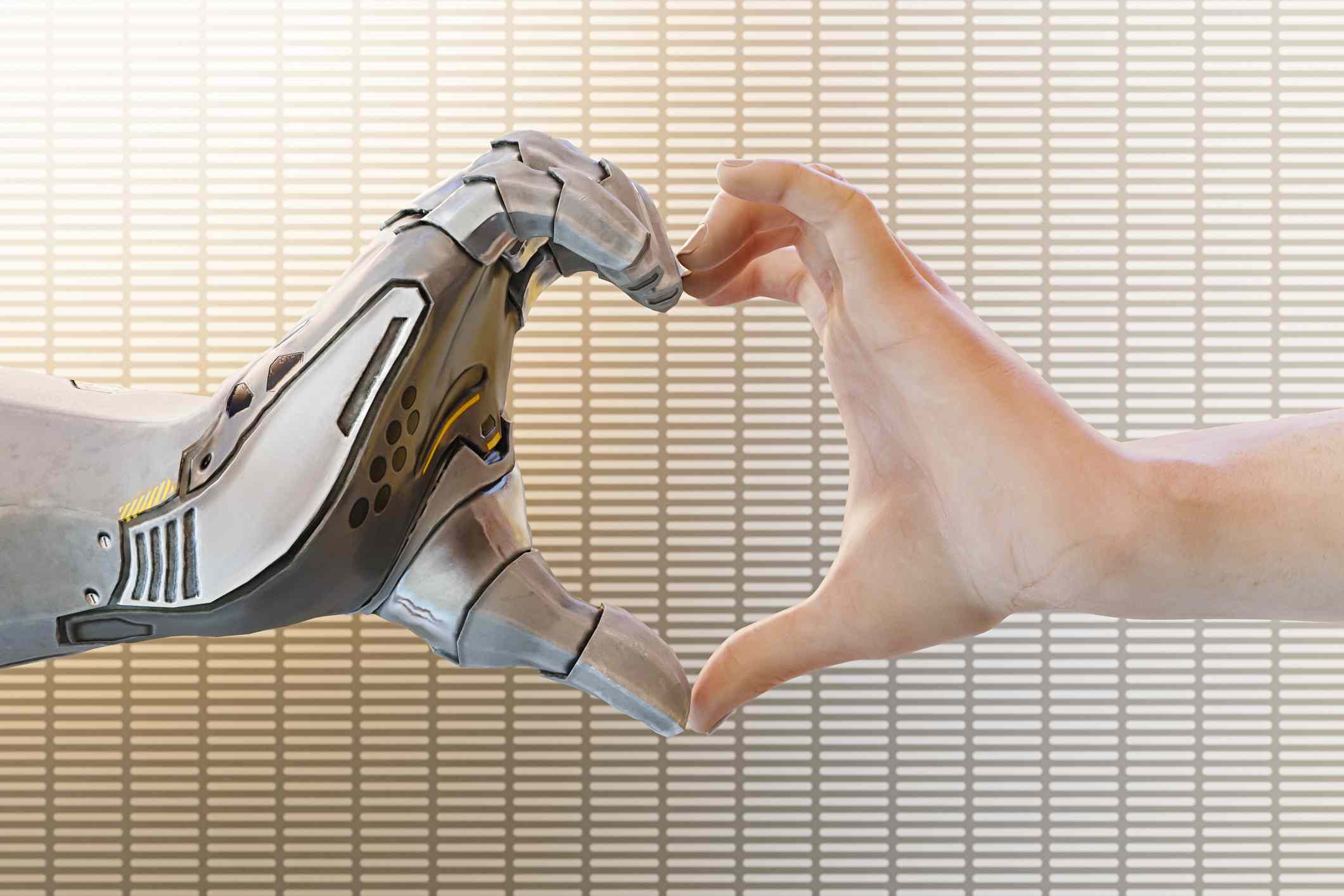 Robottikäsi ja ihmisen käsi muodostavat sydämen muodon. 