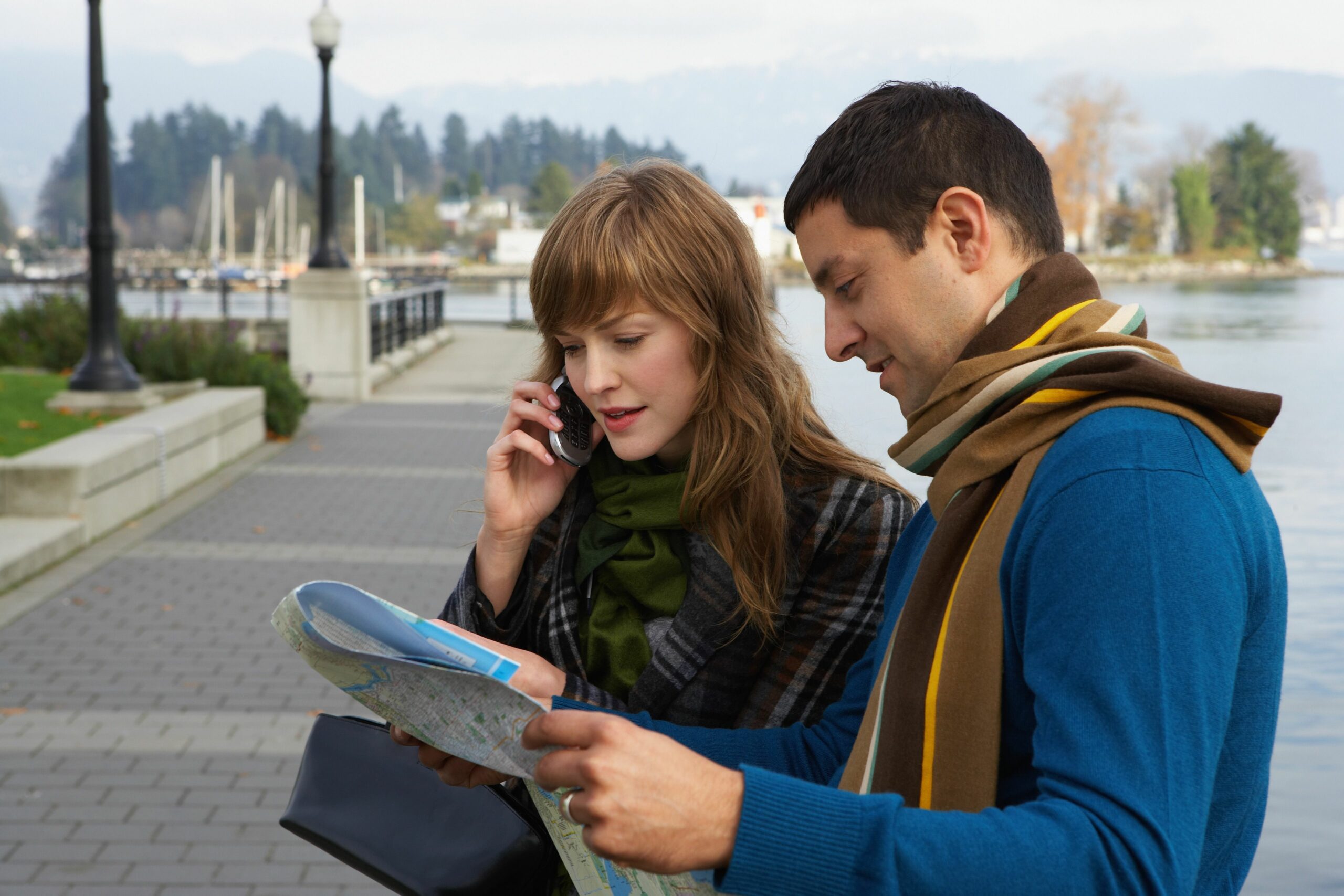 couple reading map on waterfront young woman using mobile phone 200326285 001 5a948525119fa80036dc10c9 scaled