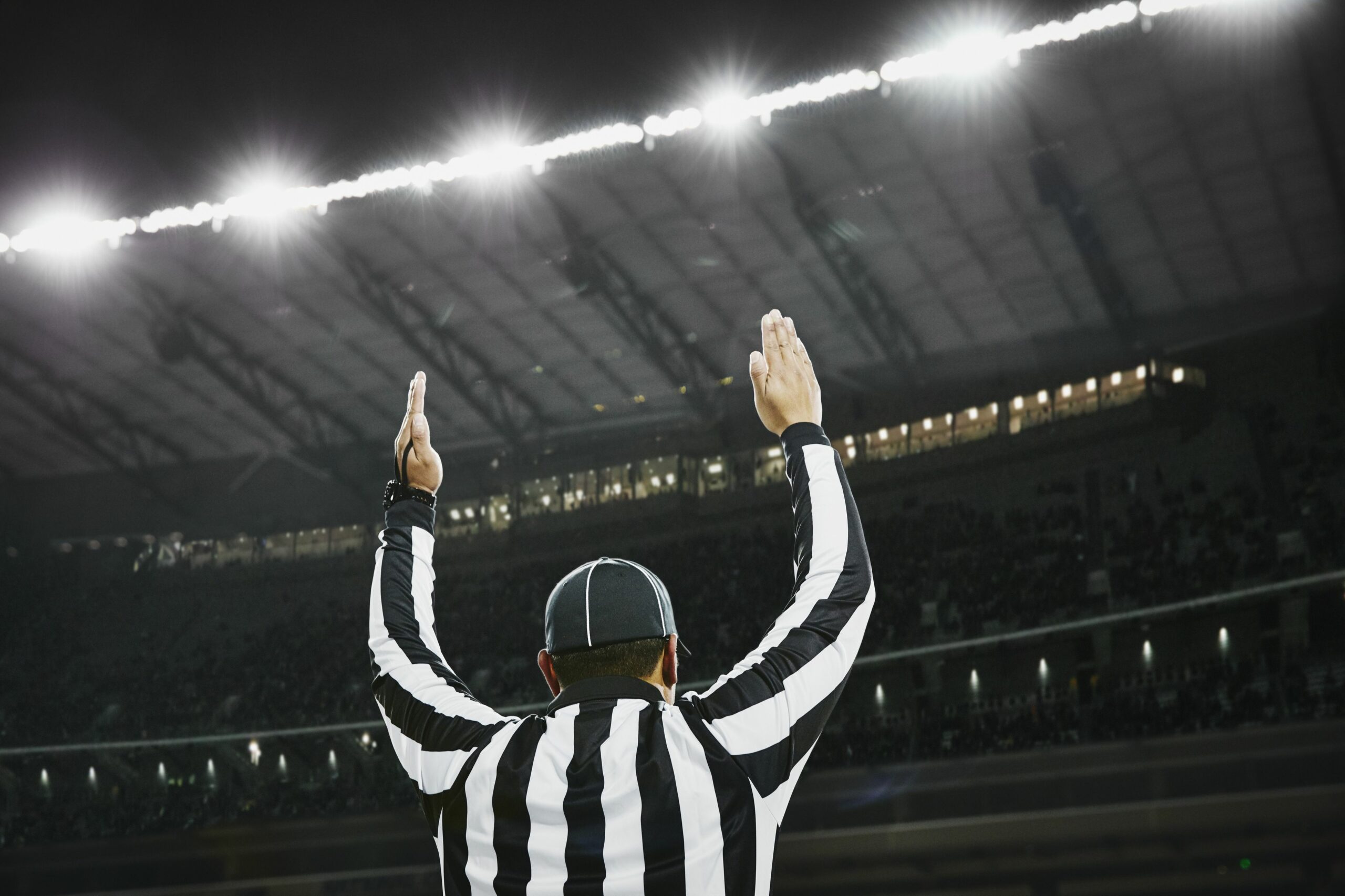 football referee signaling touchdown in stadium 599944339 5a84cb9e875db900367df025 scaled