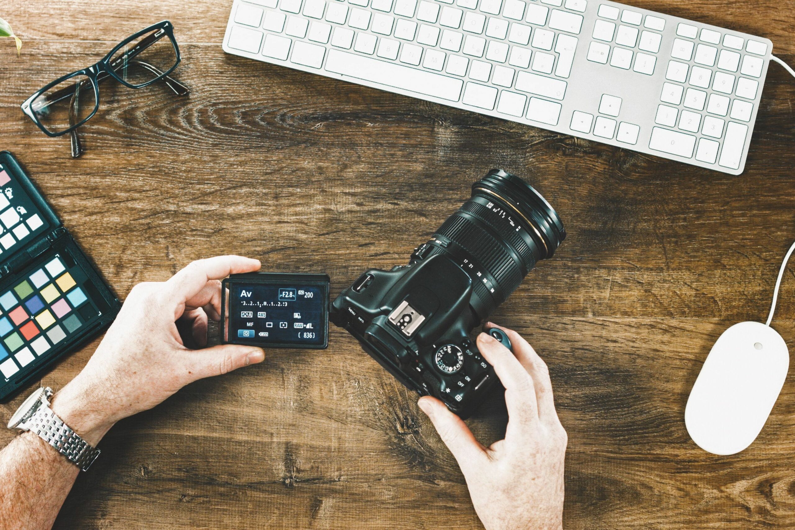 high angle view of man holding camera at table 877994880 5b1e840e3037130036d9bc07 ad7221e1c34b4f9db5991a98ddc0a775 scaled