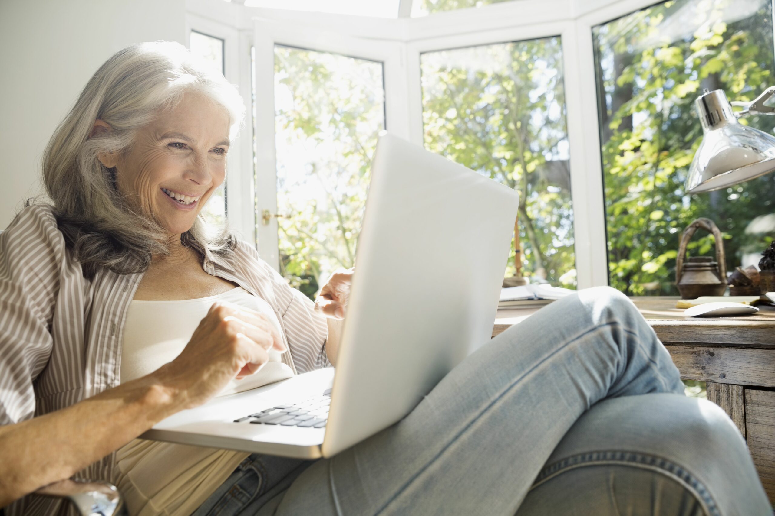 senior woman using laptop in sunny home office 530053781 5a3aab640c1a82003643d1df scaled