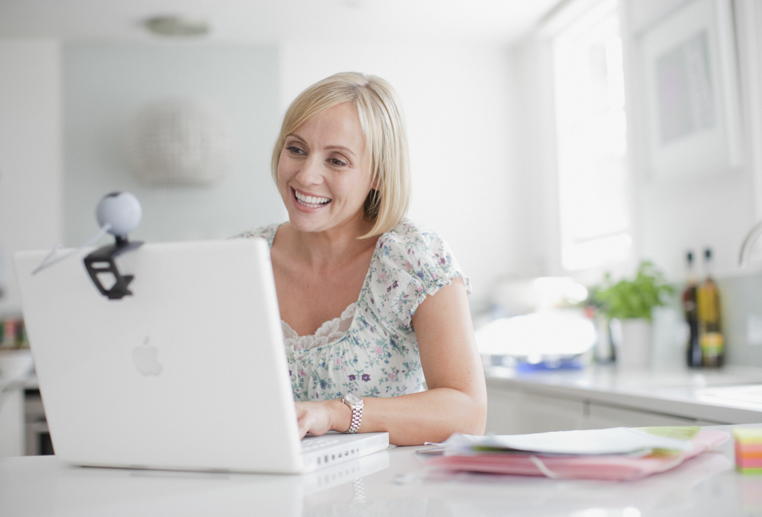 smiling woman enjoying video chat on laptop 107429015 5b475cae46e0fb005b292f02 scaled