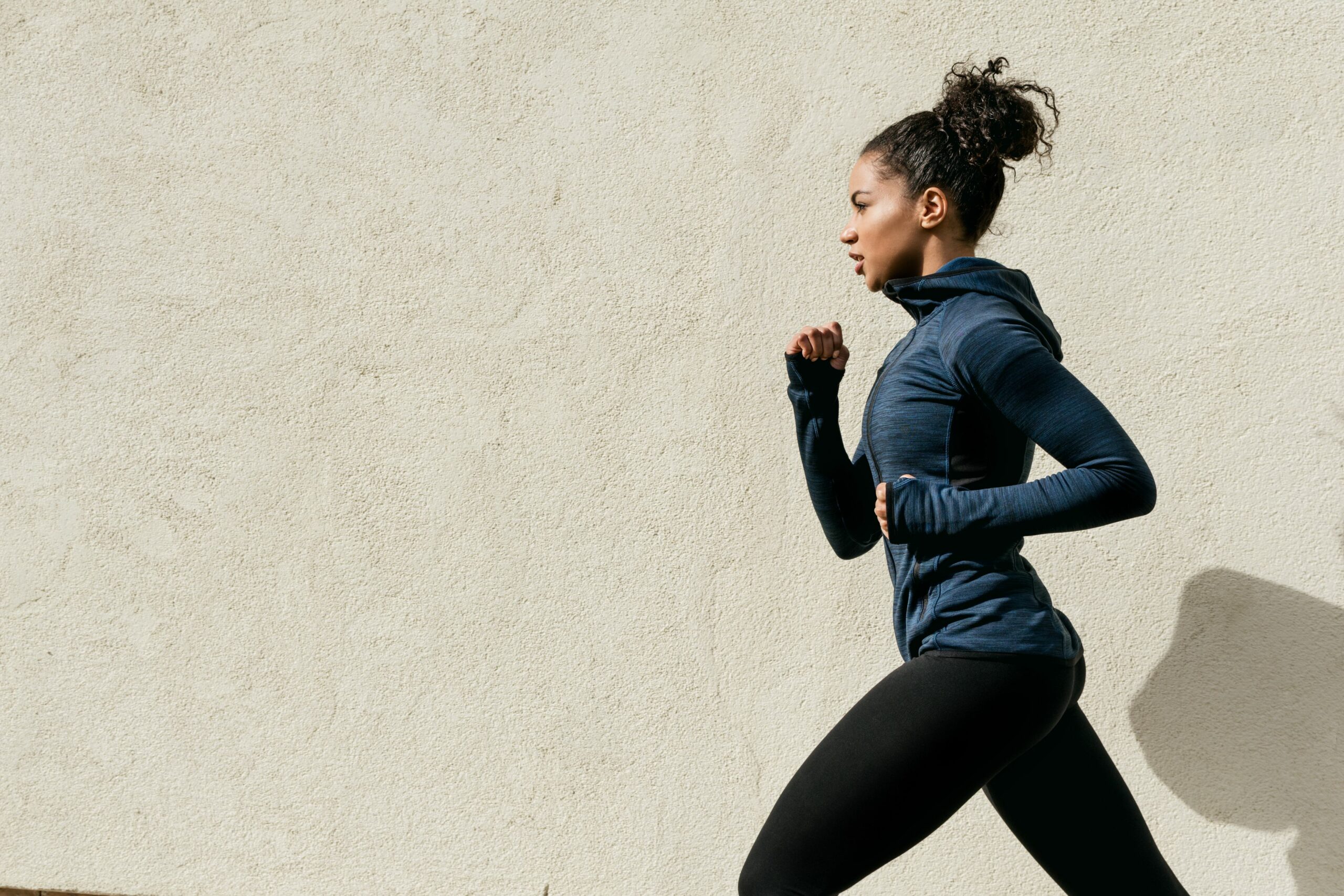 woman running against wall 930134532 5c1413f94cedfd000154b034 scaled