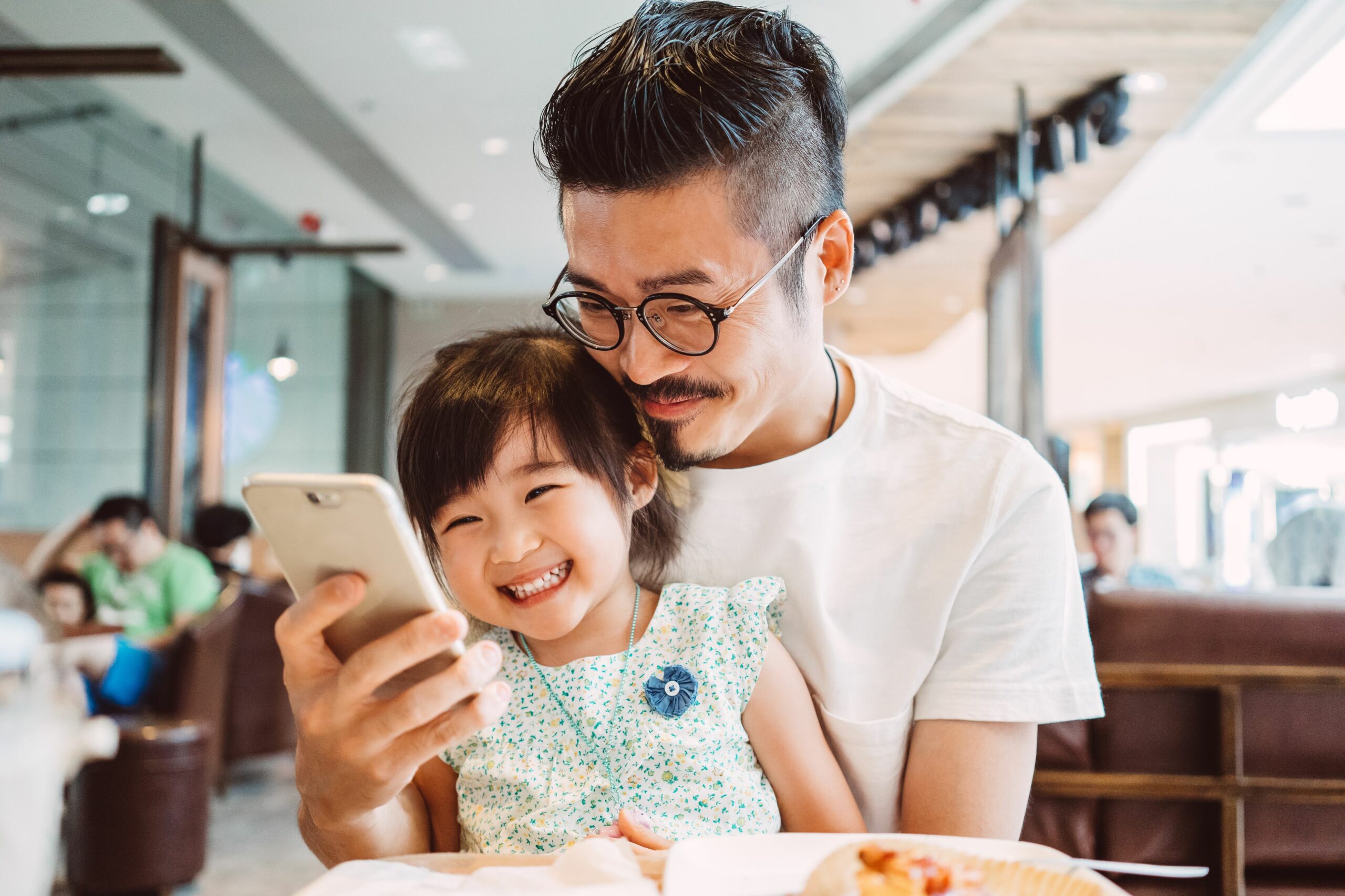 young dad using smartphone with little daughter 581036187 5b27338d8e1b6e003656e8f2 scaled