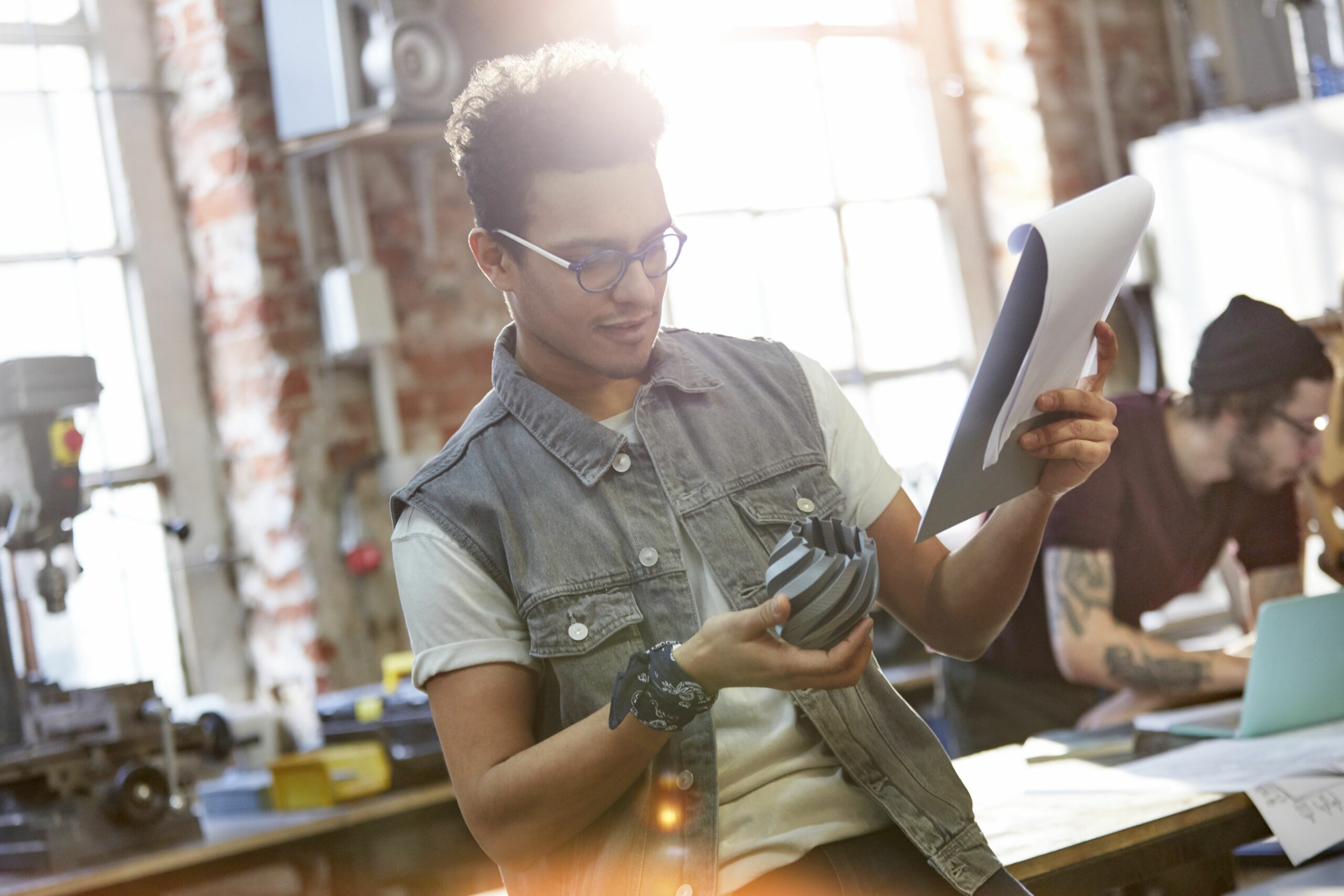 young male designer examining prototype and notes in workshop 750415319 5a036498aad52b00374ed3a5 scaled