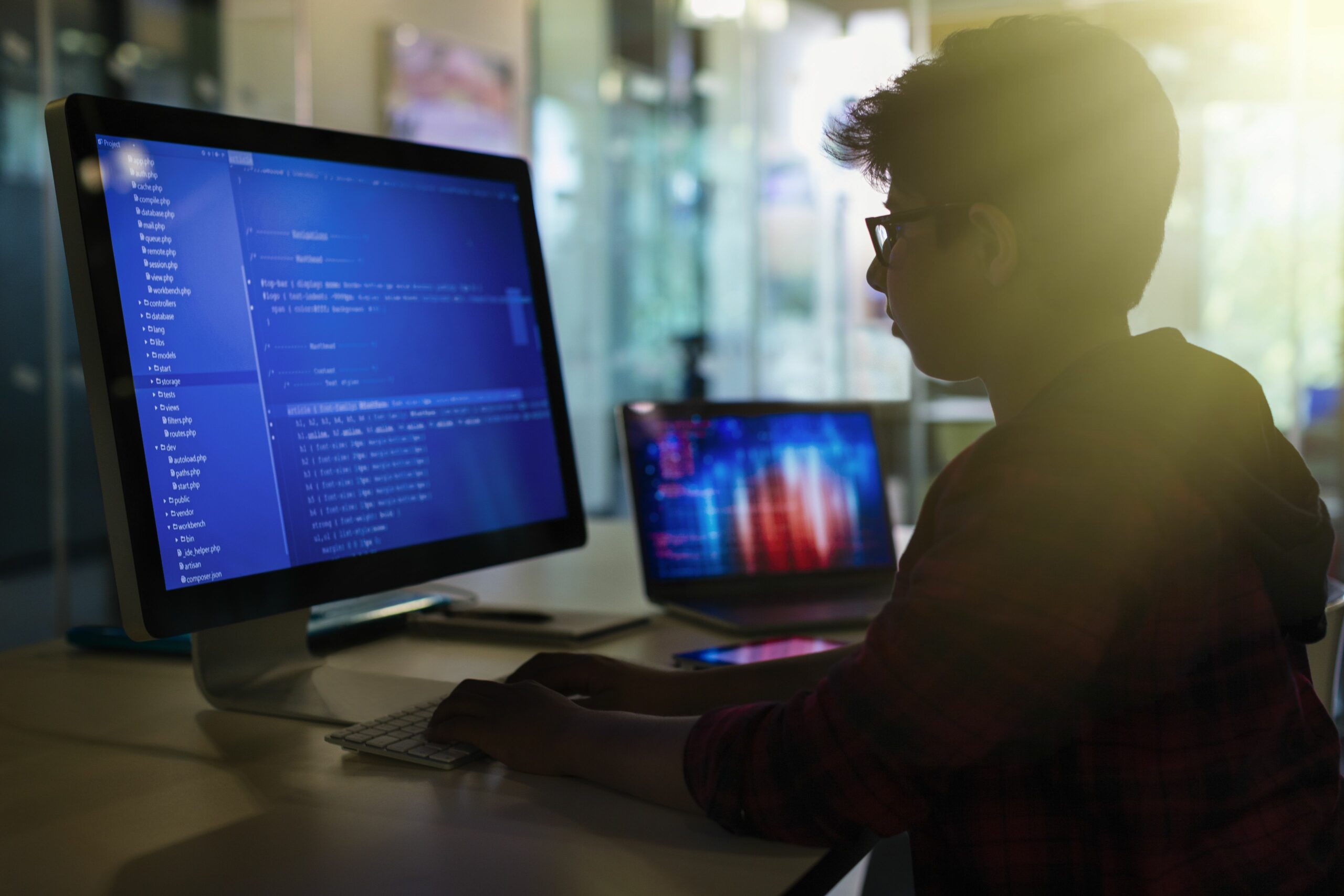 boy student programming at computer in dark classroom 922709192 5be618f4c9e77c00517709dc scaled