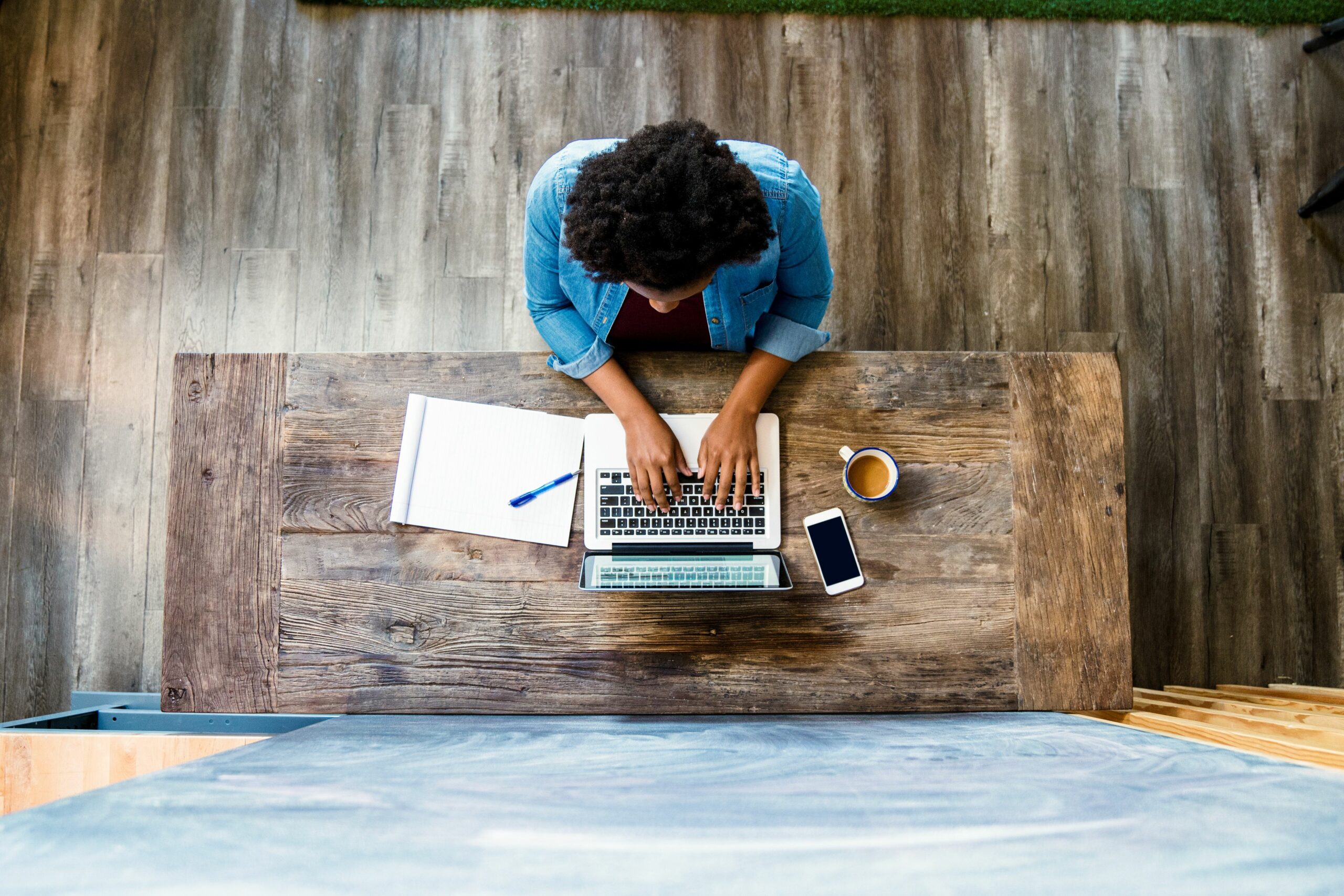 overhead view of a woman using a computer 626172712 5b4a789146e0fb00375d2205 scaled