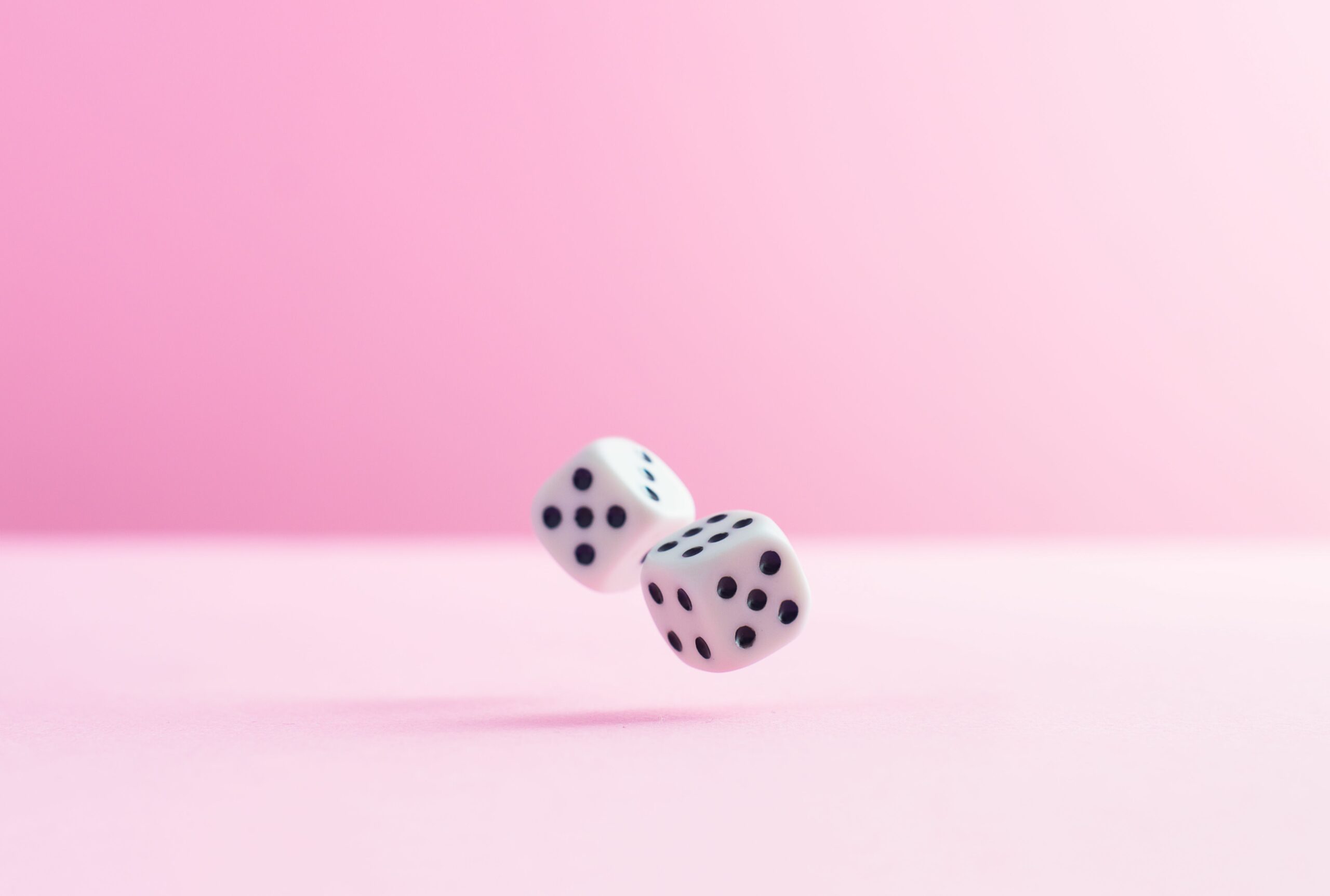 studio shot of two dice over pink background 724318579 5af48f64a474be003778933d scaled