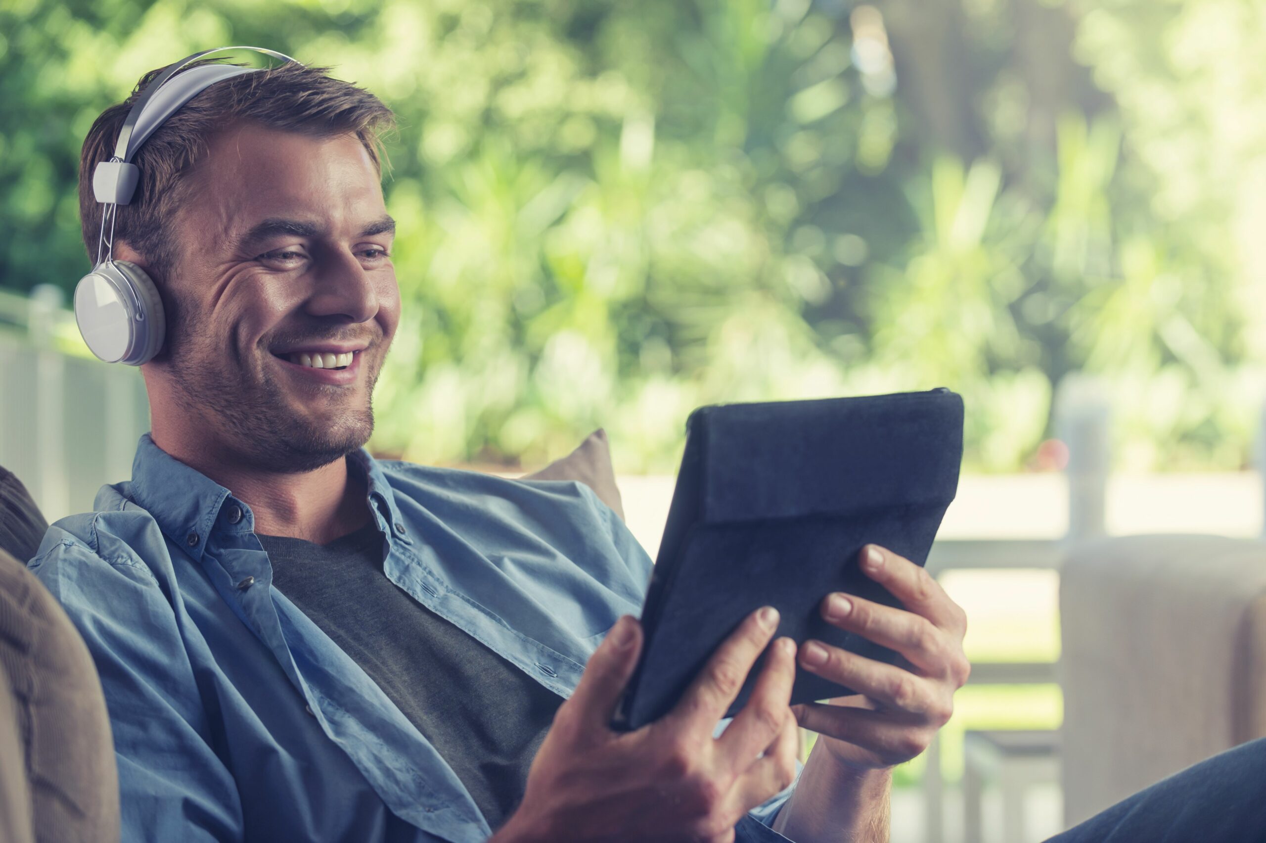 young man listening to music with a digital tablet 504222904 5b27623e119fa80036547693 scaled