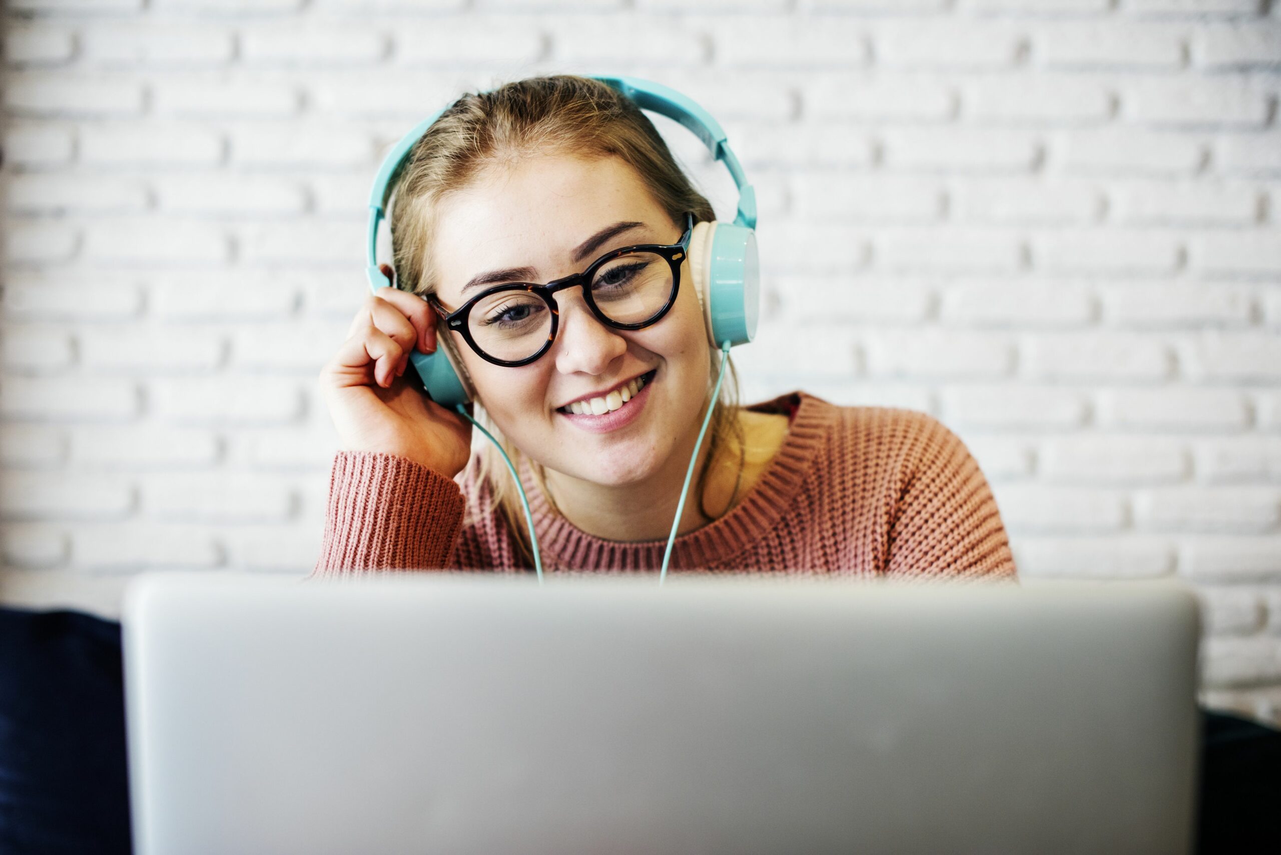 young woman listening to music 948416228 5afc8ef50e23d90037f96893 scaled