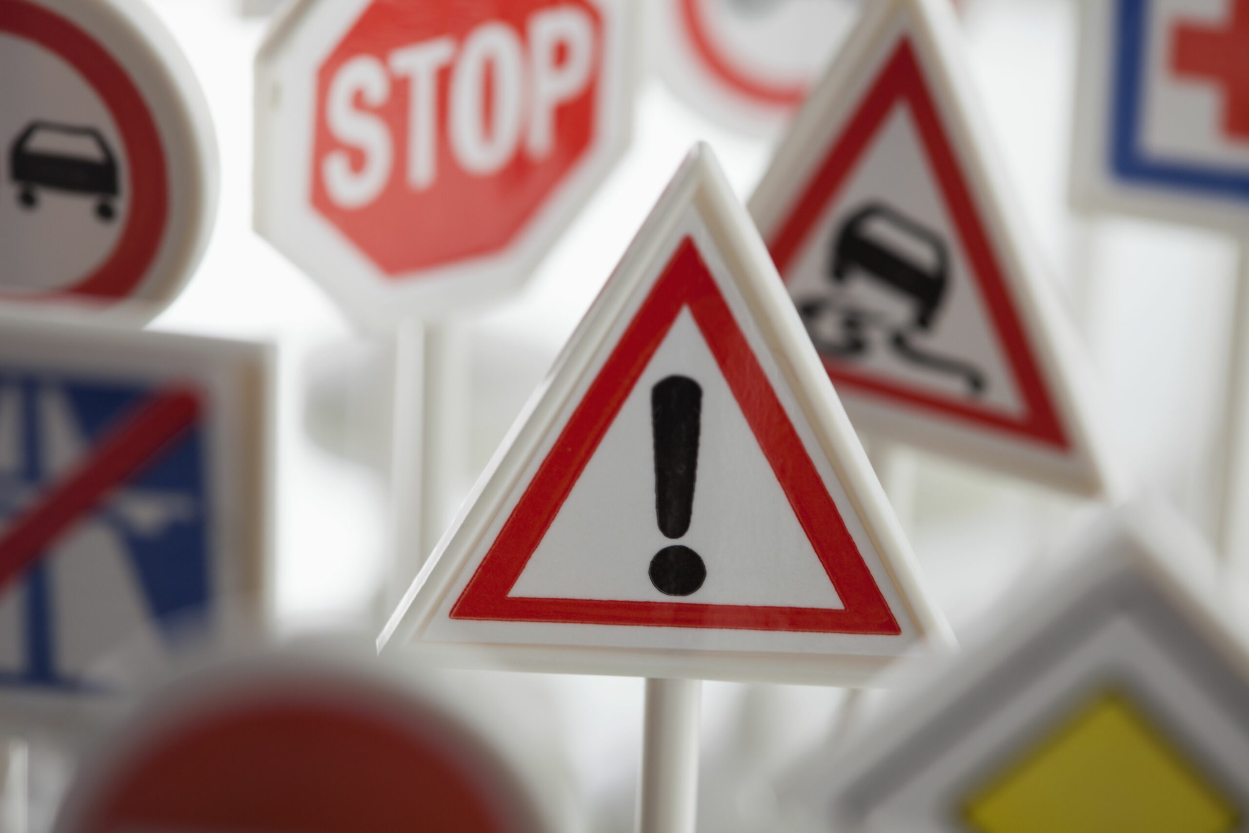 a toy hazard sign surrounded by other various road warning signs 450741917 593c61b83df78c537b475bc2 scaled