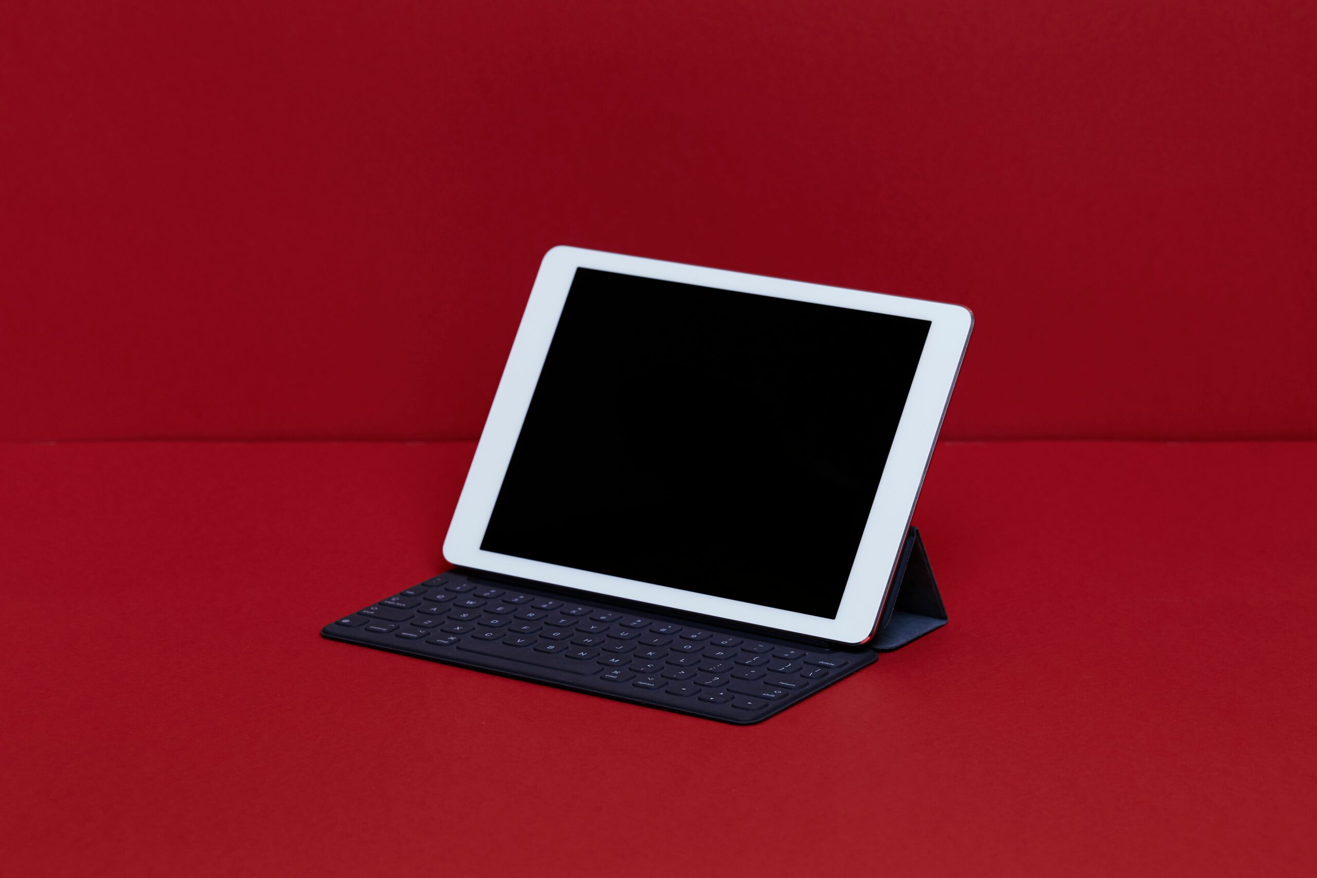 close up of digital tablet with keyboard on red table 910893214 5c64aa3d46e0fb0001dcd881 scaled