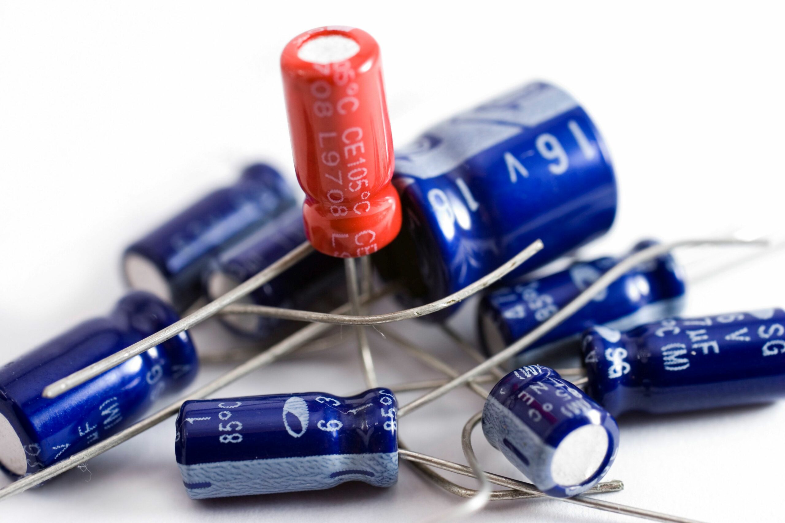 collection of capacitors against a white background 172962646 5b778f7146e0fb0050598827 4e75dd0fc0a240a4a9f46b6596b157ef scaled