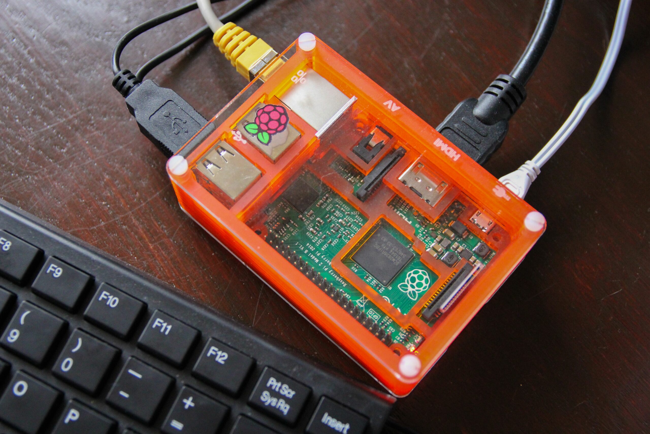 raspberry pi in an orange clear case 517985140 5b3640c3c9e77c0037e9a77a scaled