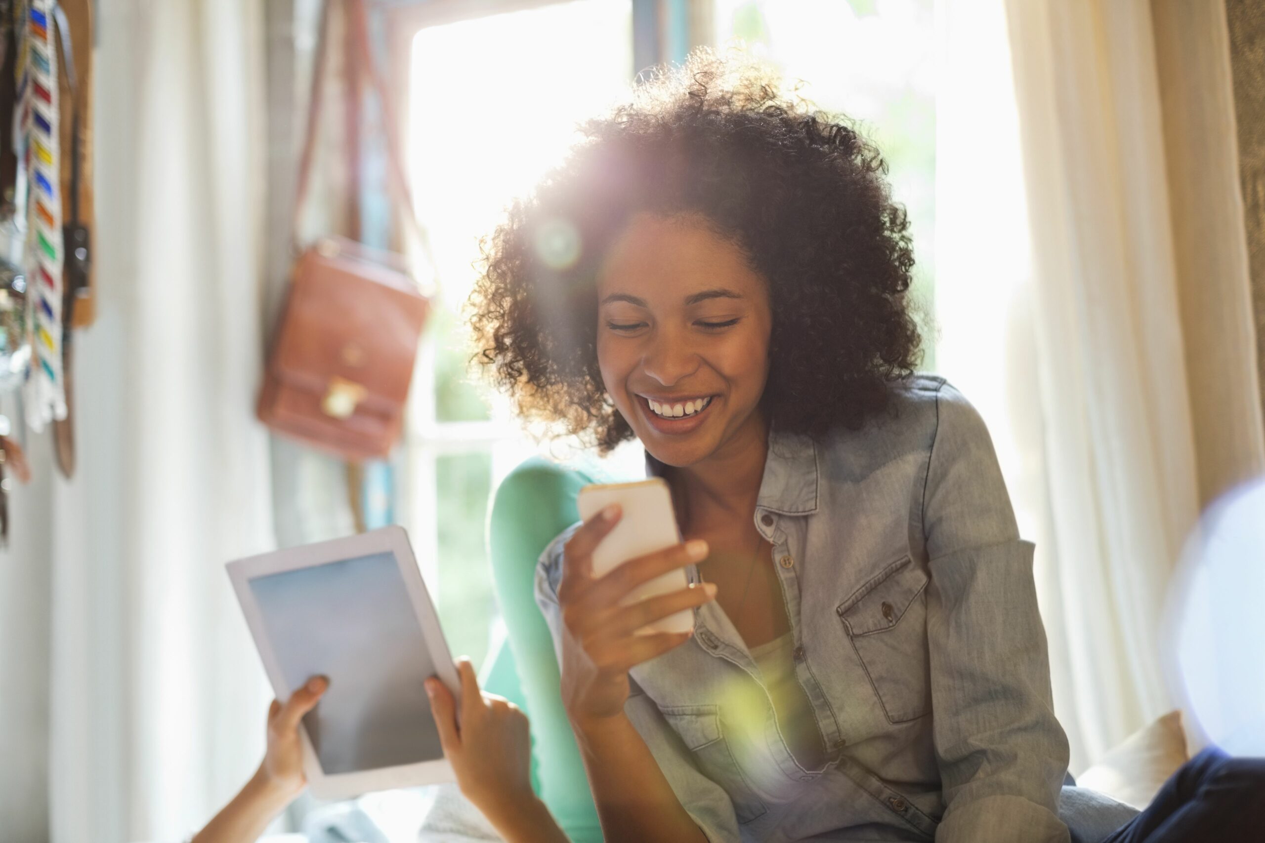 women using tablet computer and cell phone in bedroom 175139715 59a5ebe2aad52b0011674b12 scaled