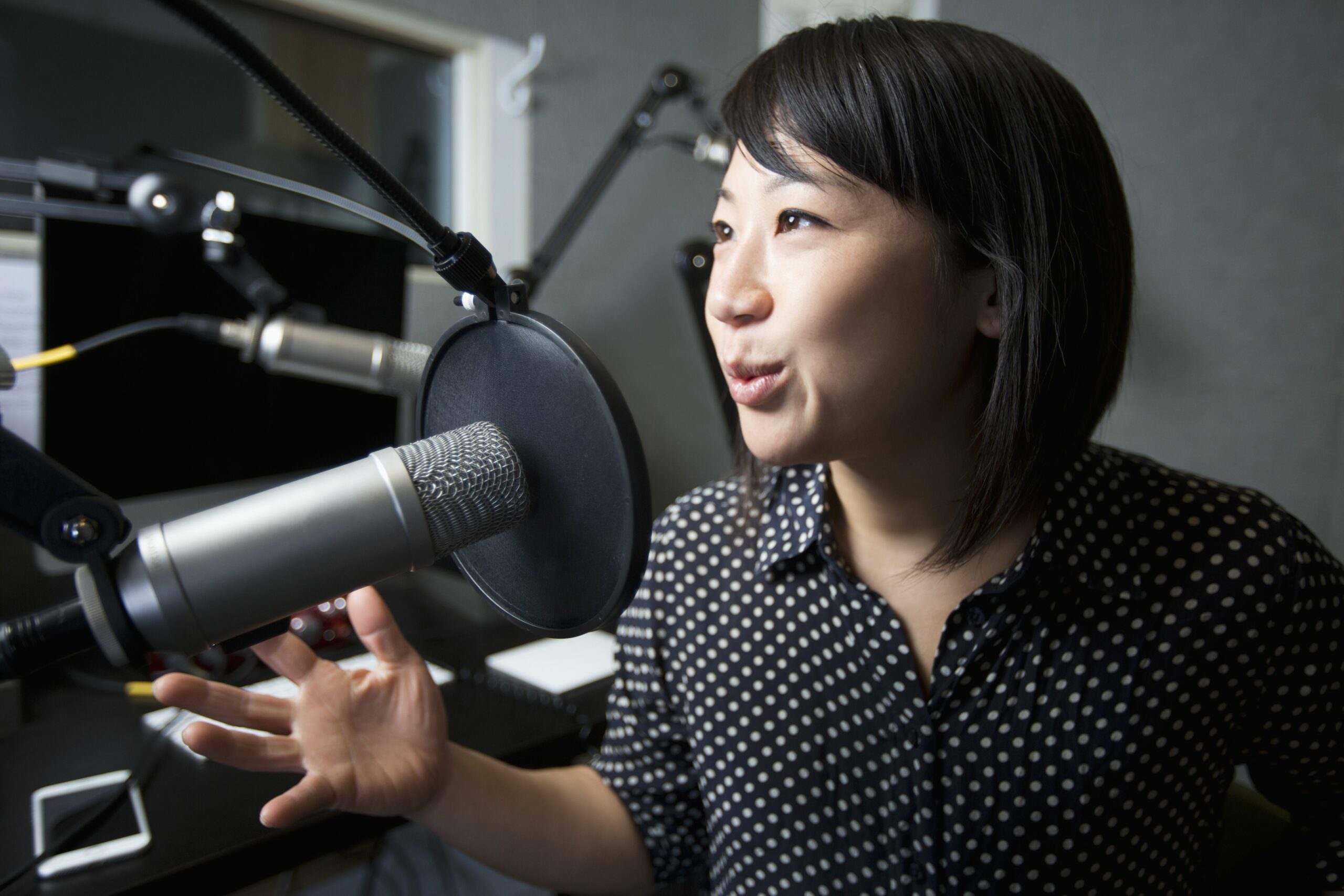 asian woman talking into microphone 722208887 5b57a0e146e0fb00718df3ae scaled