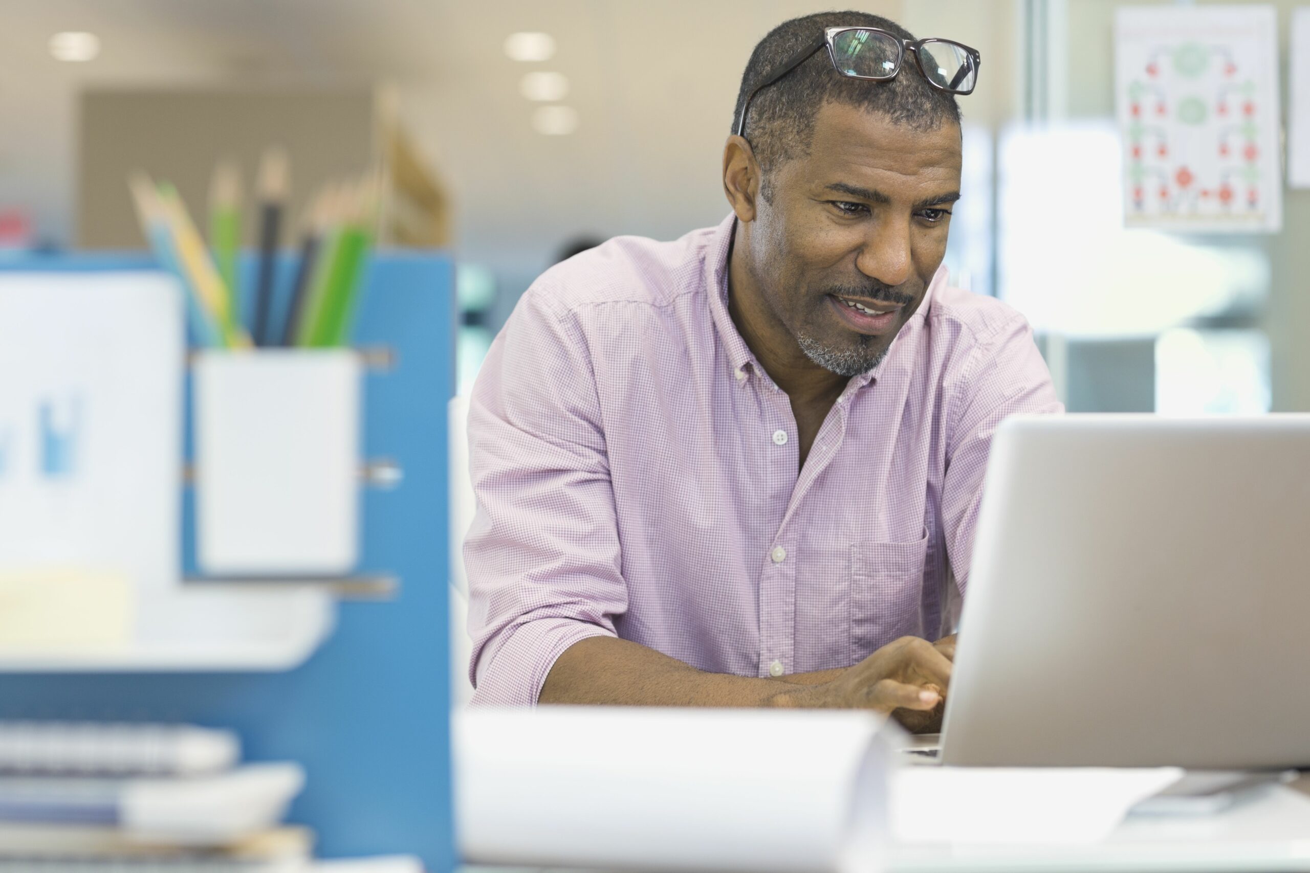 businessman using laptop at office desk 463028797 5a39c567482c52003617c420 scaled