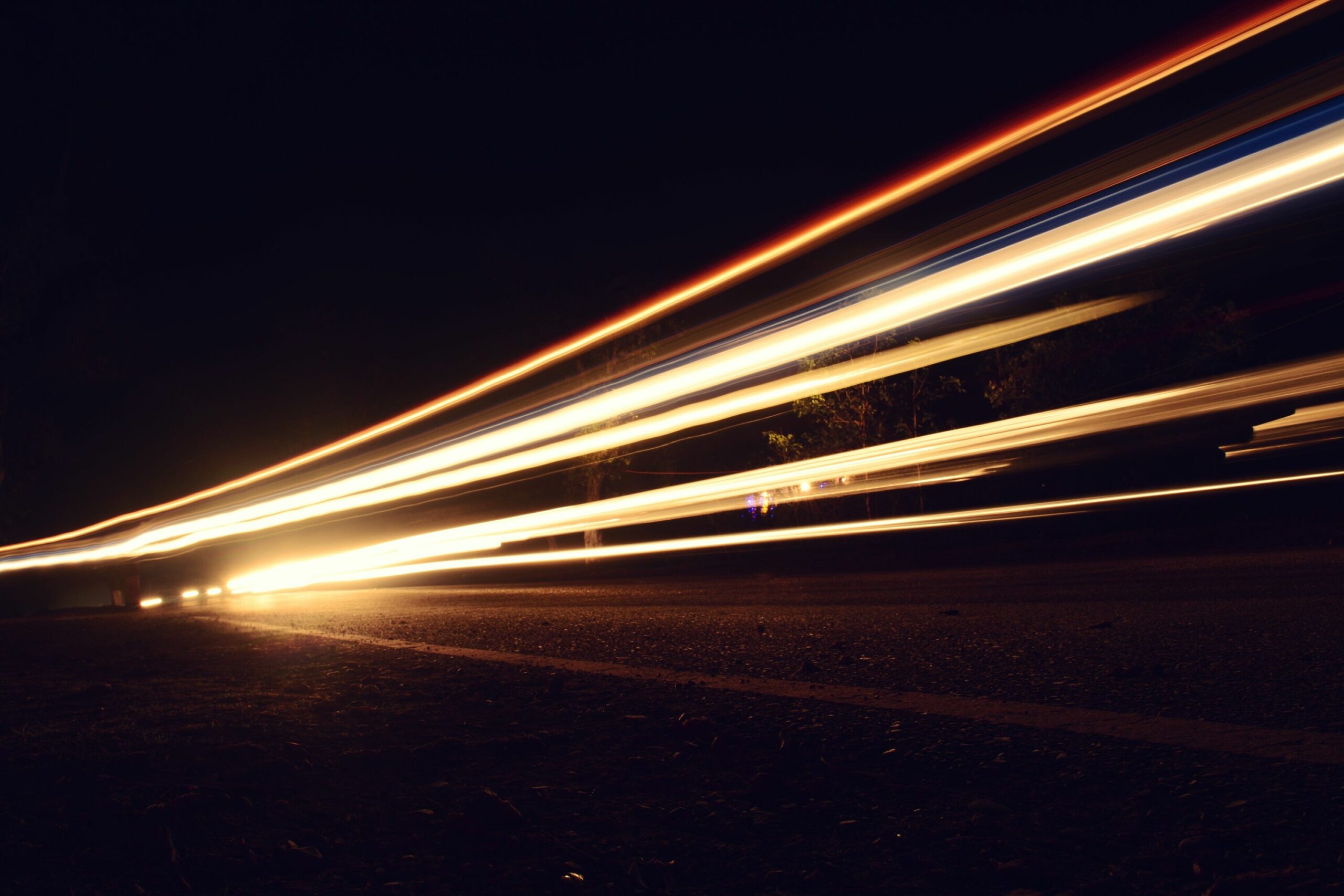 light trails on road against sky at night 928301234 72e1abde1bb2402d891f73074a10edfb scaled