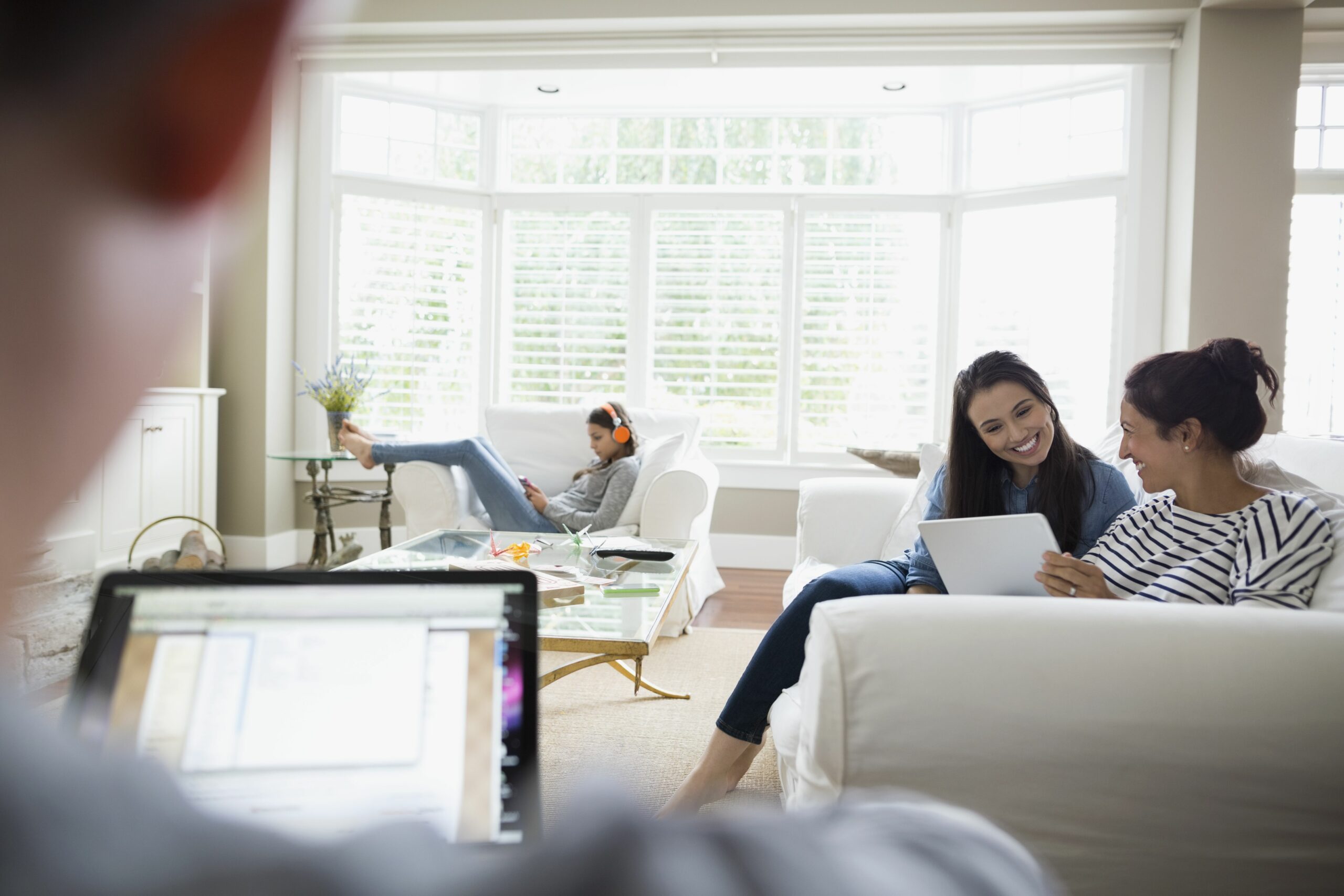 mother and daughter digital tablet living room sofa 595347375 596fa97ad088c000104b4af5 scaled