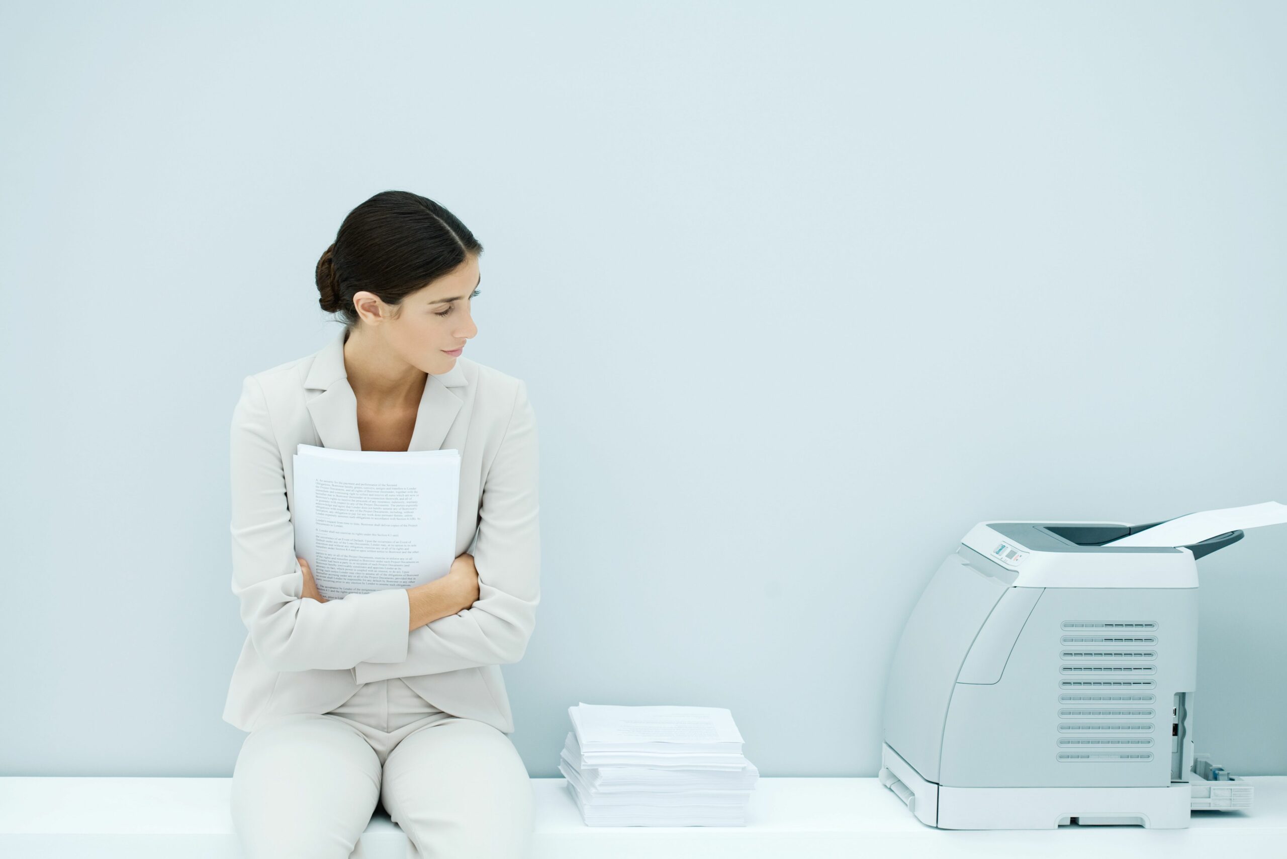 young woman in suit sitting next to printer 81737128 5b2afc9543a10300367c44f4 scaled