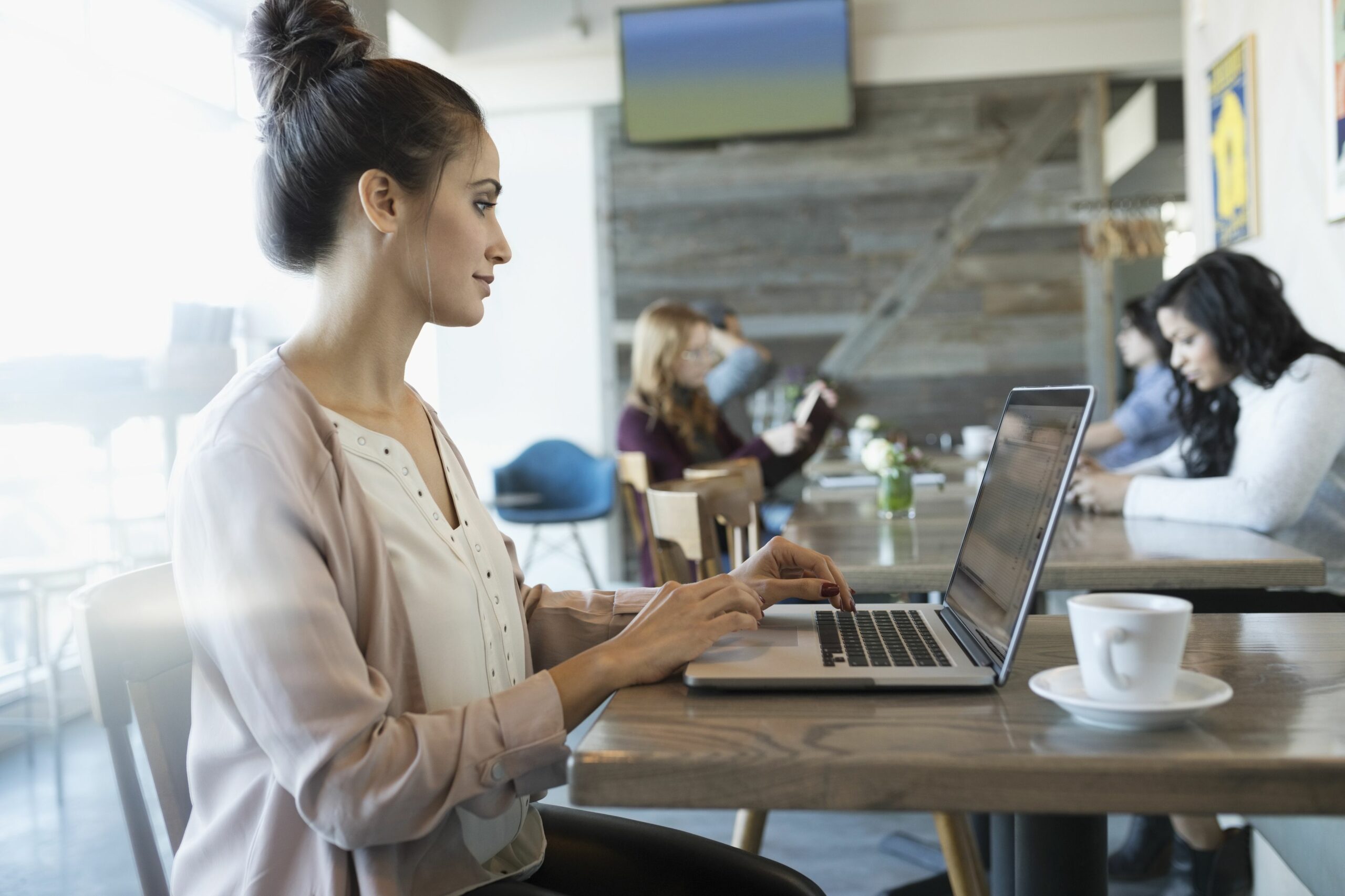 businesswoman working at laptop in cafe 956747198 5af9a488642dca00370fa646 scaled