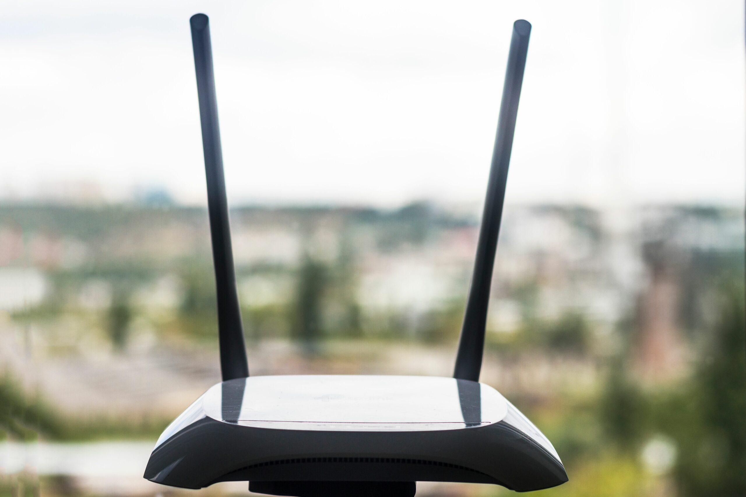 close up of wireless router by window 1025071730 5c4bac4346e0fb0001a8e6e6 scaled