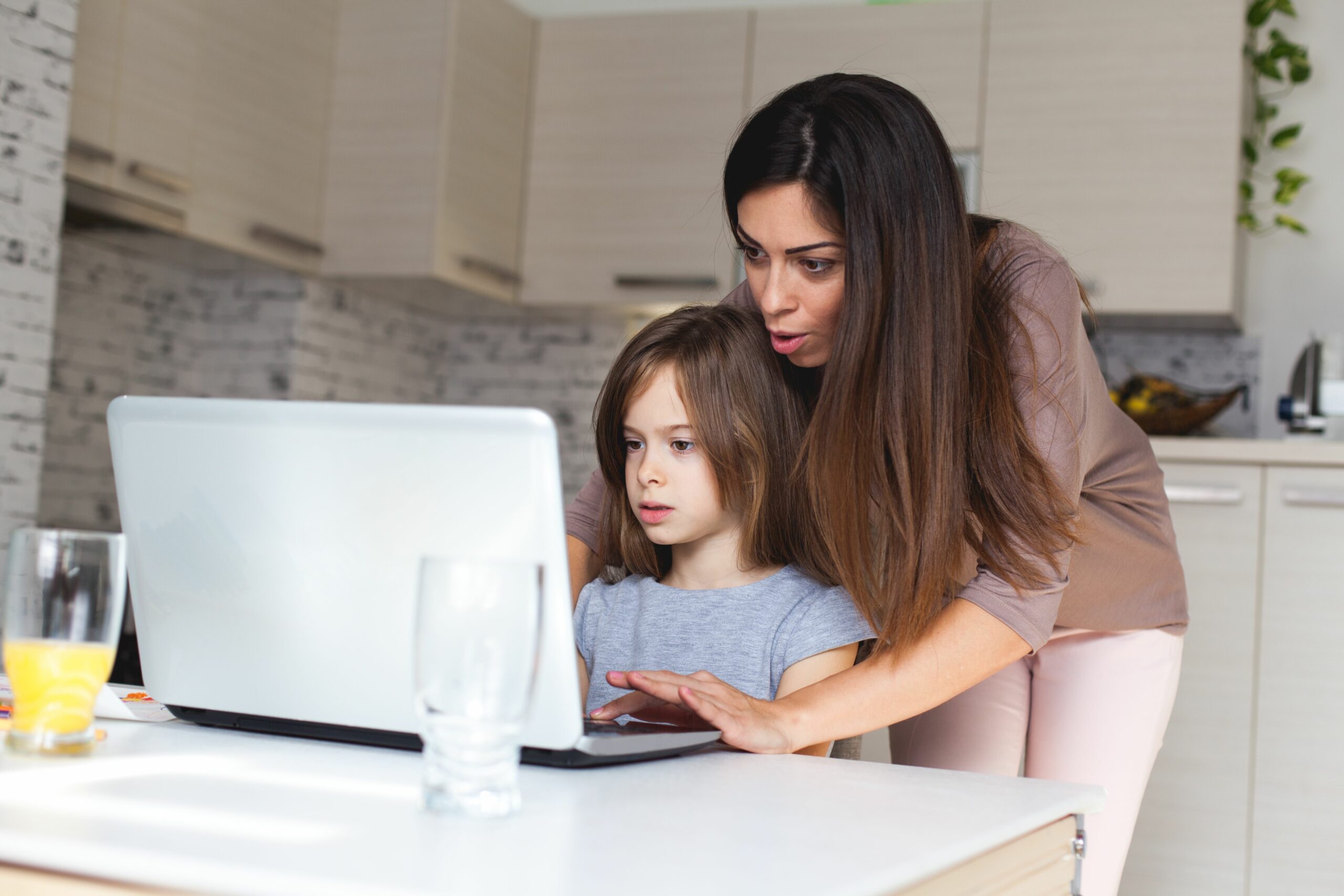 cute girl and mother using laptop at home 621830380 5b84905d4cedfd00258fa836 scaled