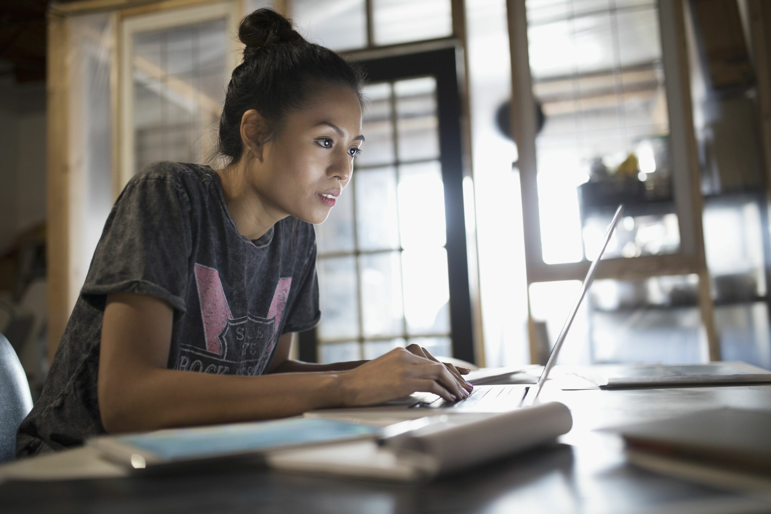 focused young woman working at laptop in office 769719673 5be9ec53c9e77c005106d18b scaled