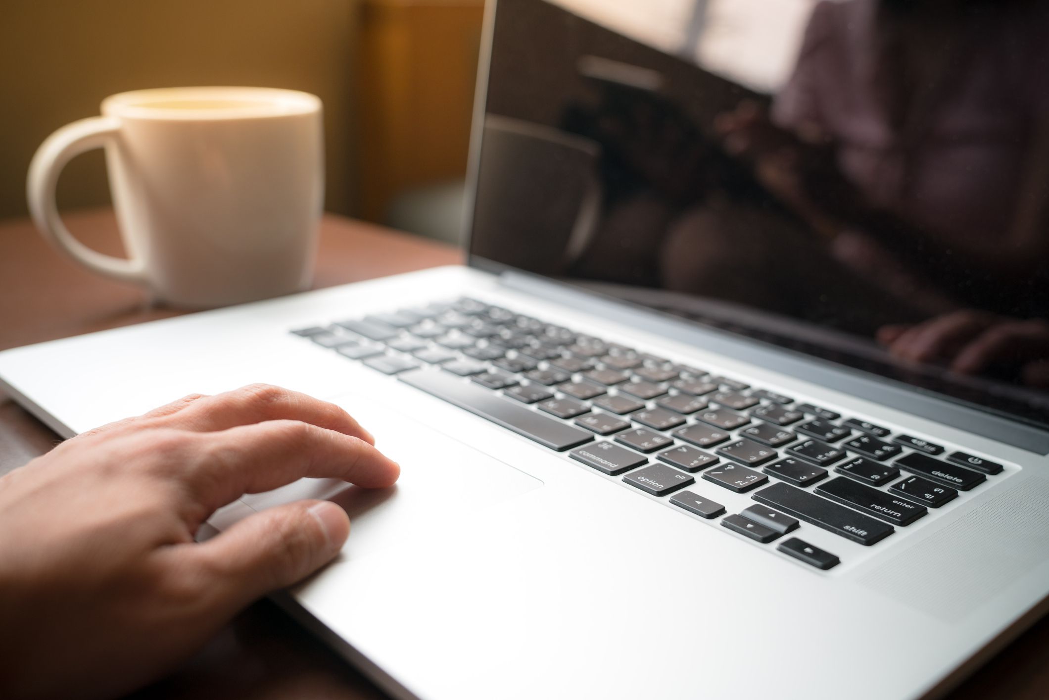 macbook in a coffee shop 5c8b91d346e0fb000177002e