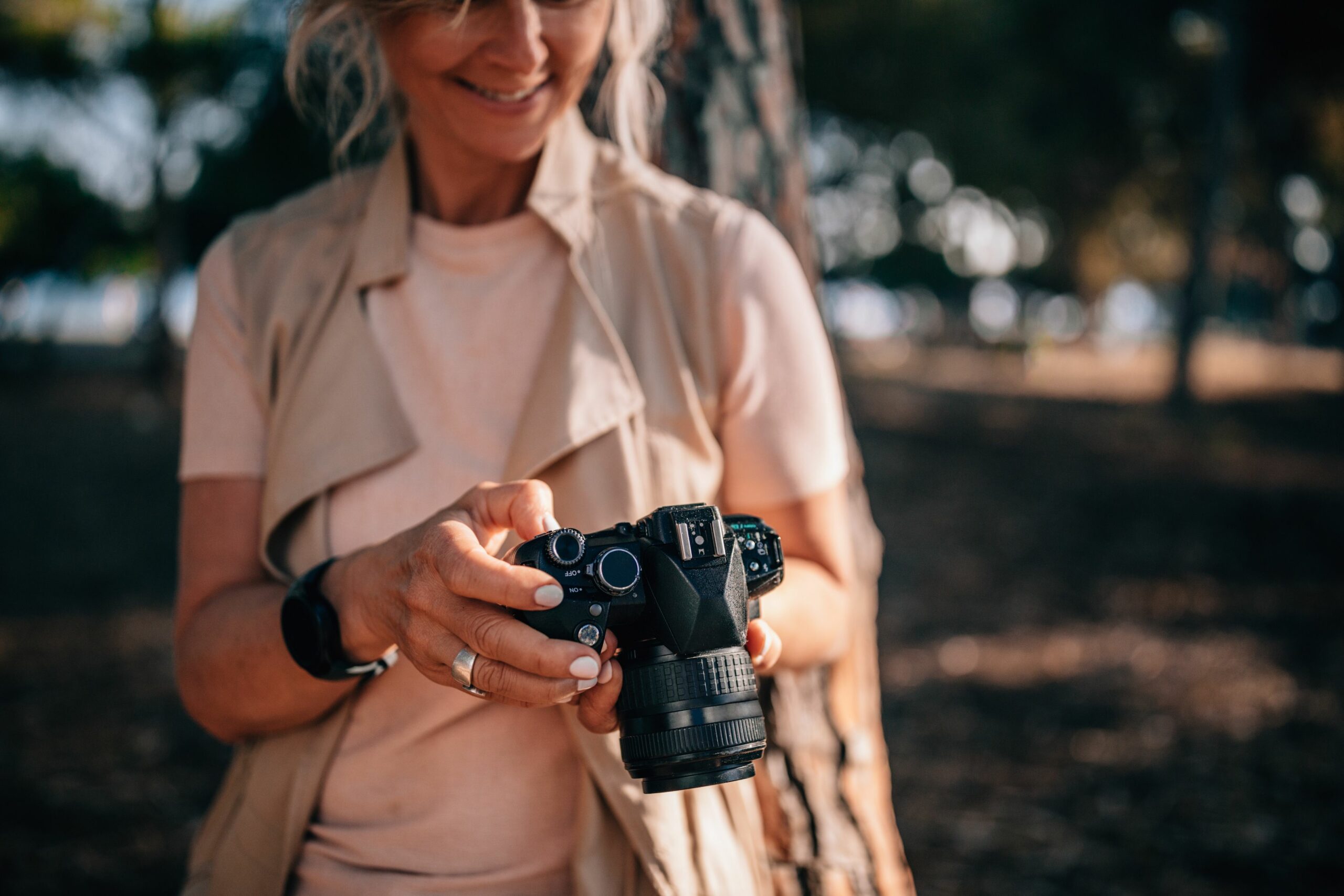 senior woman using camera and looking at photos in nature 979294778 5c0a9ea6c9e77c0001eb82a6 scaled