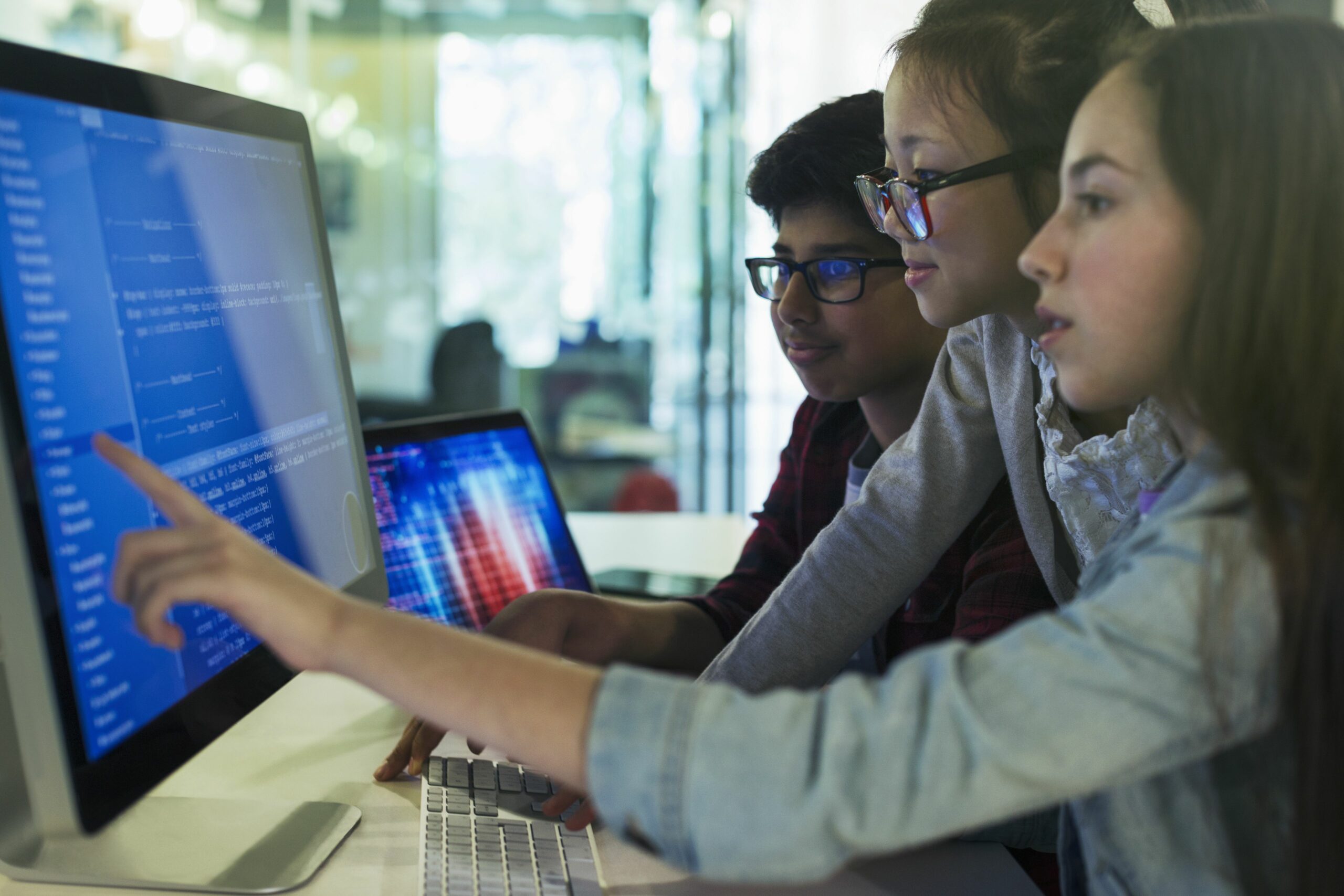 students programming at computer in computer lab classroom 922708902 b796c8ae338c41fbb97220c3775024fc scaled