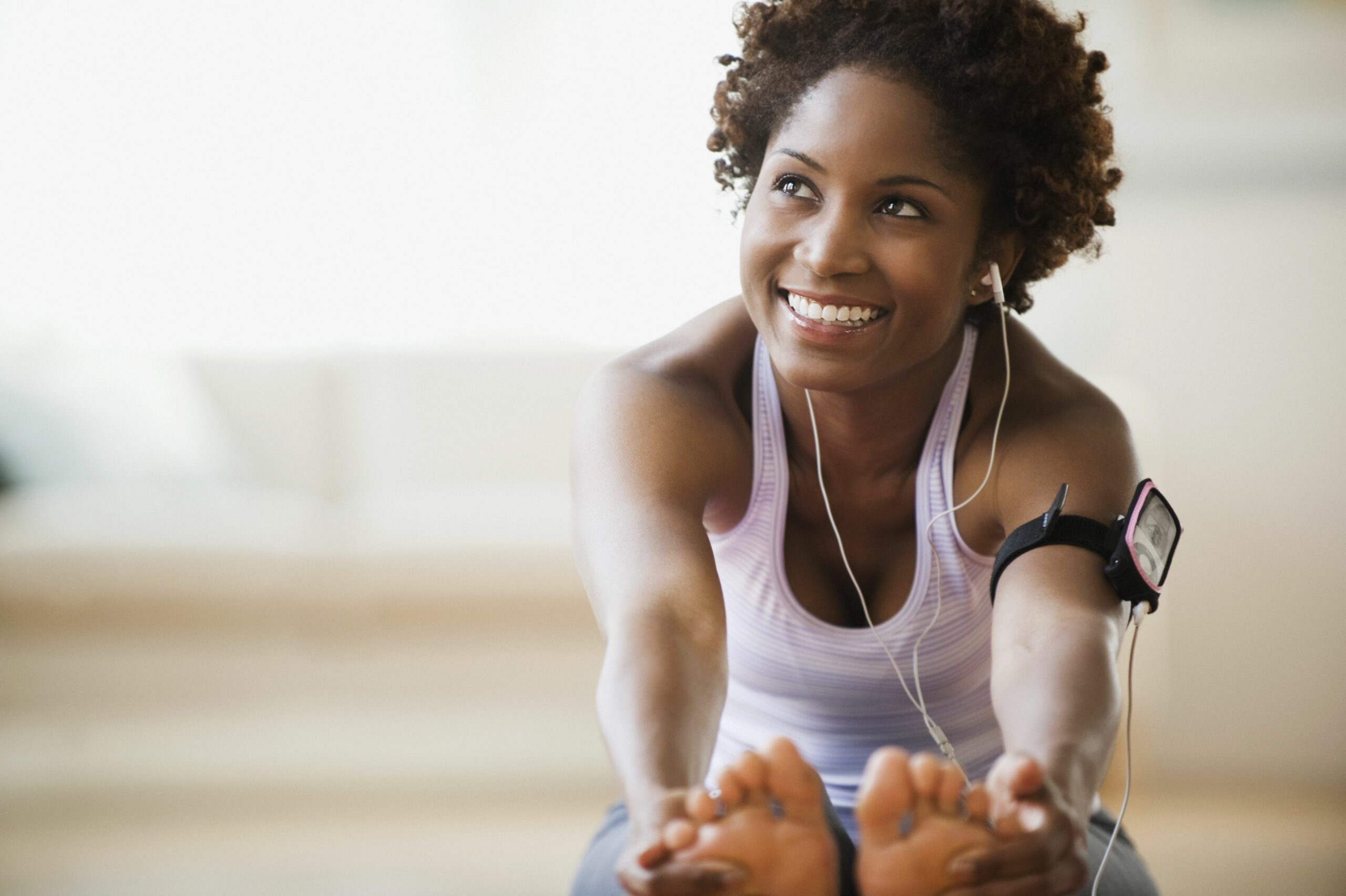 woman stretching listening to music 5761842d5f9b58f22ee37a66 scaled