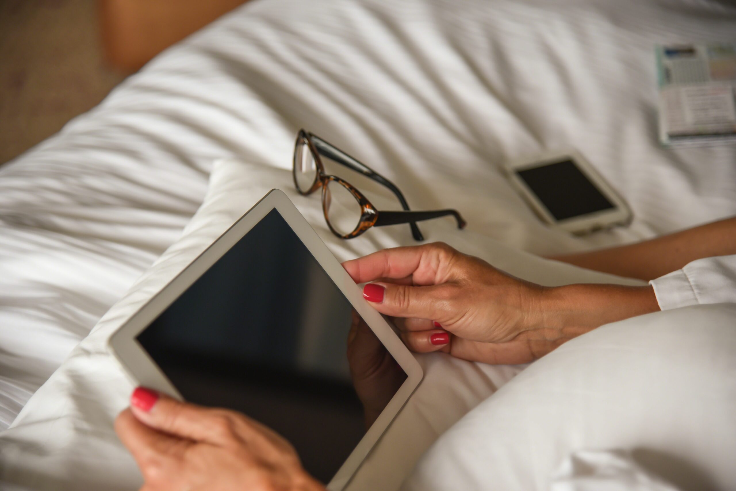 woman using digital tablet on bed 760250981 5b8460bec9e77c005744bba4 scaled