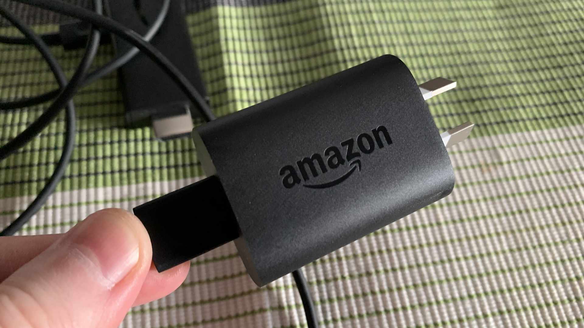 Amazon Fire Stick -verkkolaite ja USB-latauskaapeli.