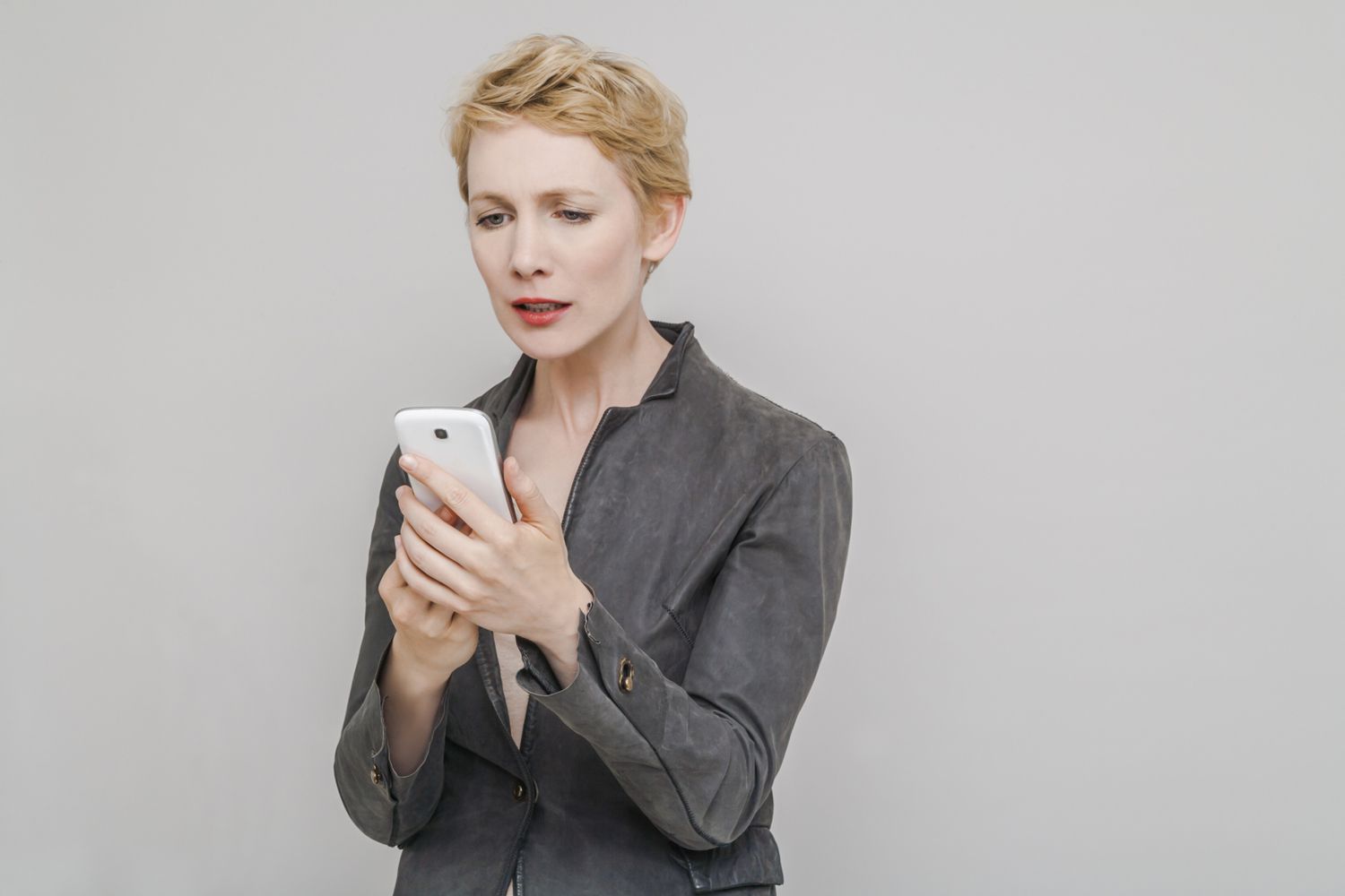 Distraught woman looking at phone 56a9d22d3df78cf772aad01f