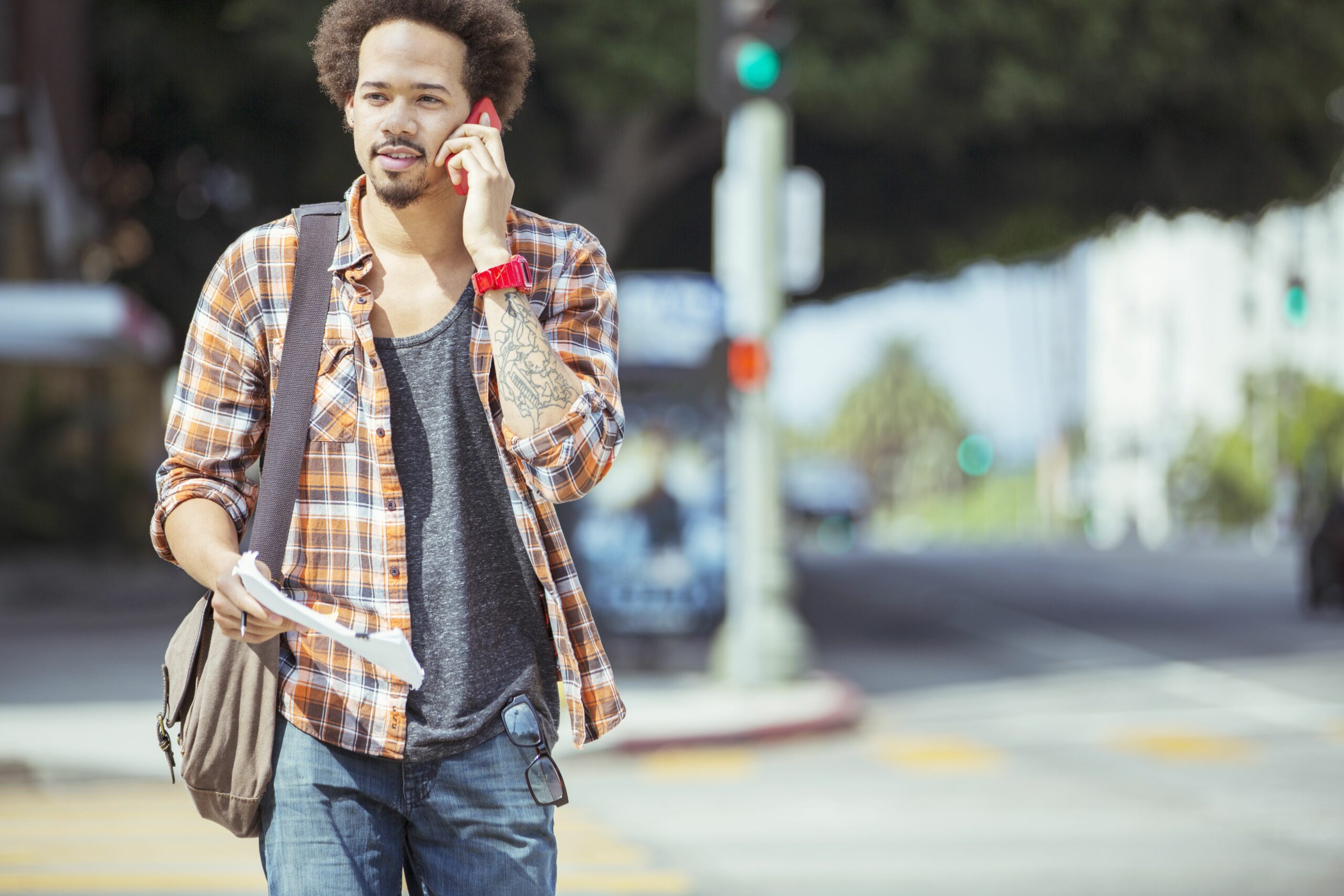 man talking on cell phone in urban crosswalk 483605653 57c44cd65f9b5855e58eea18 scaled