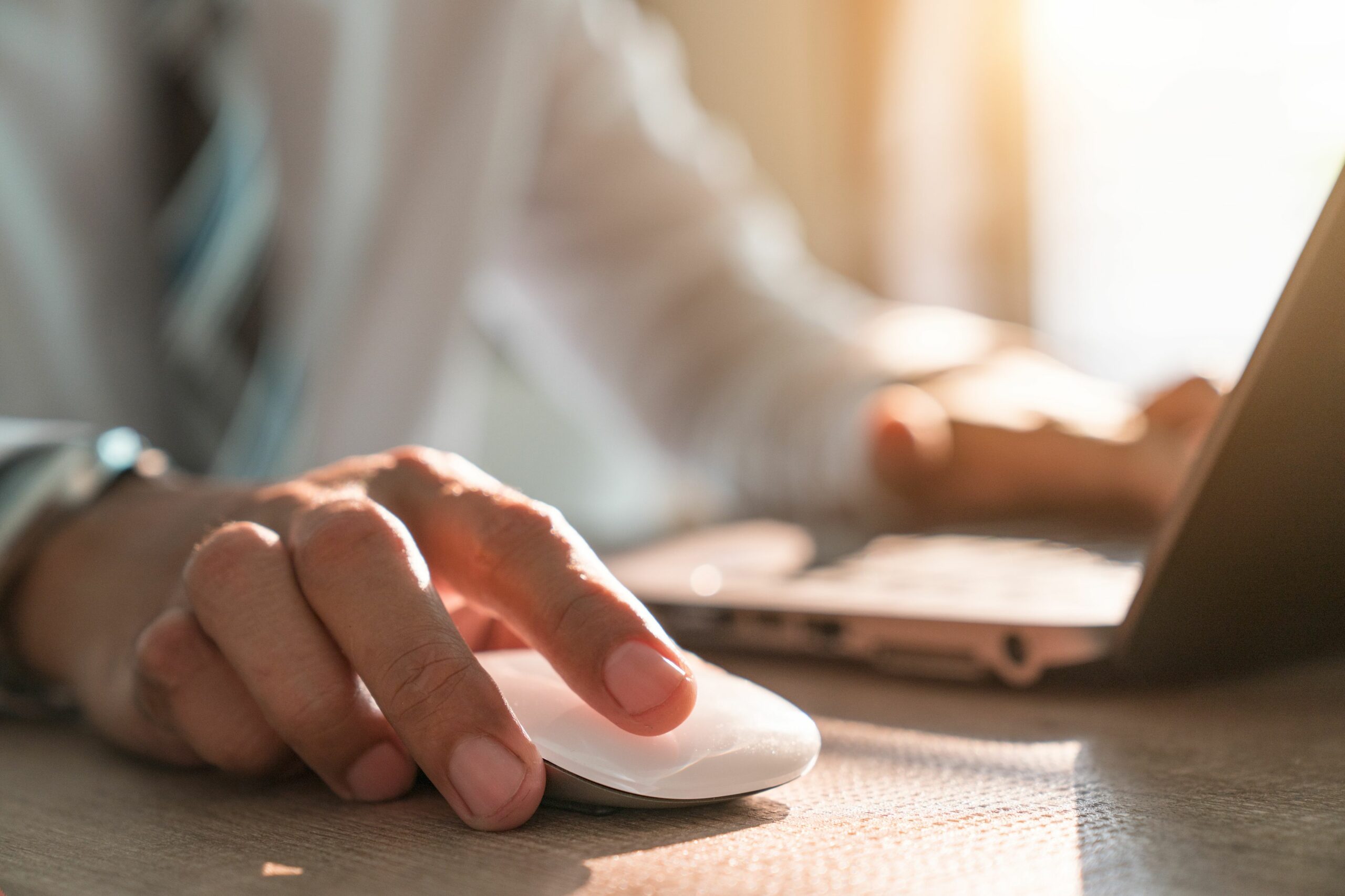 online business ideas male hand holding computer mouse with laptop keyboard in the background 929912106 5be498ff46e0fb0051062280 scaled