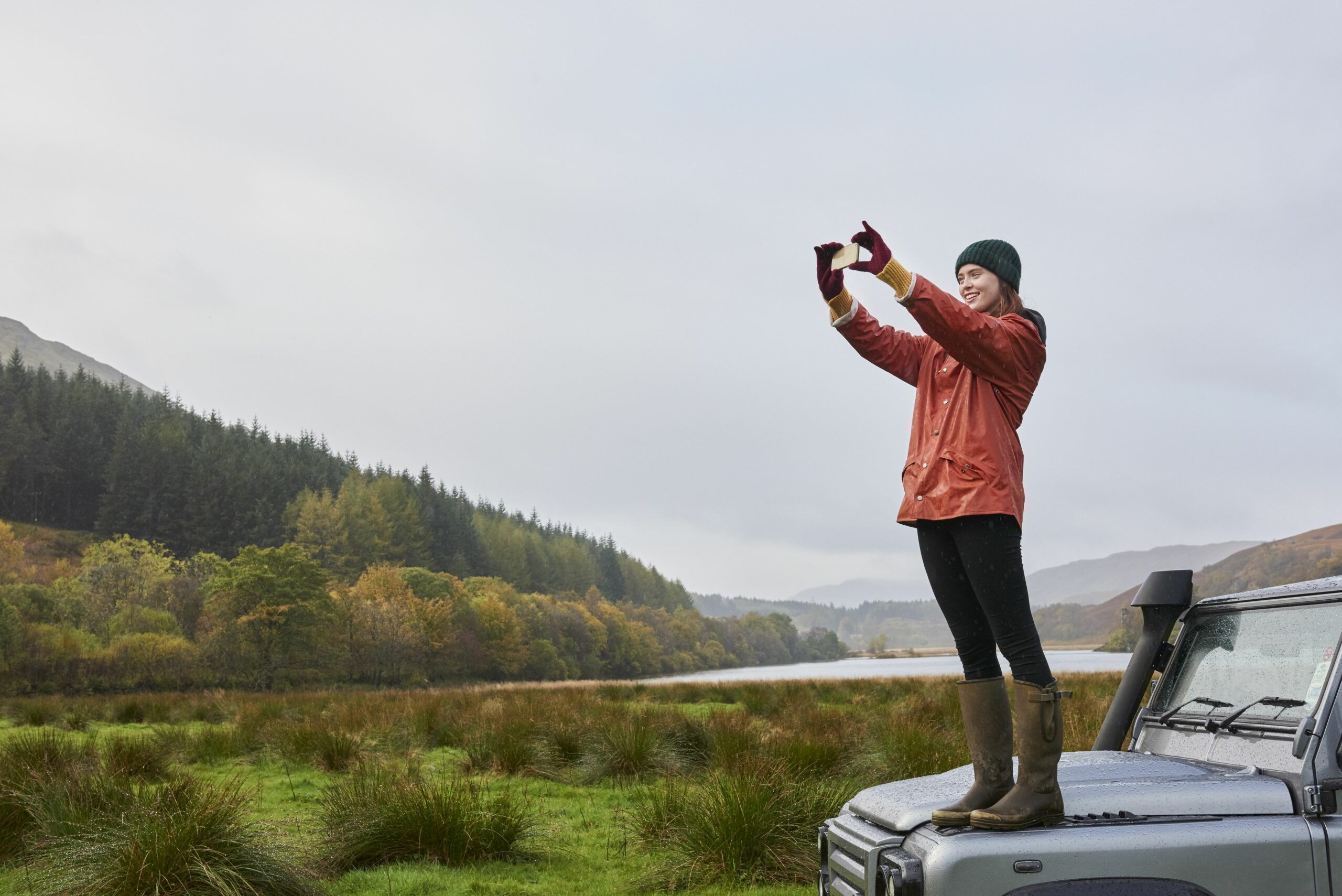 woman standing on car taking photo 690697177 5ad91adc0e23d9003673769e scaled