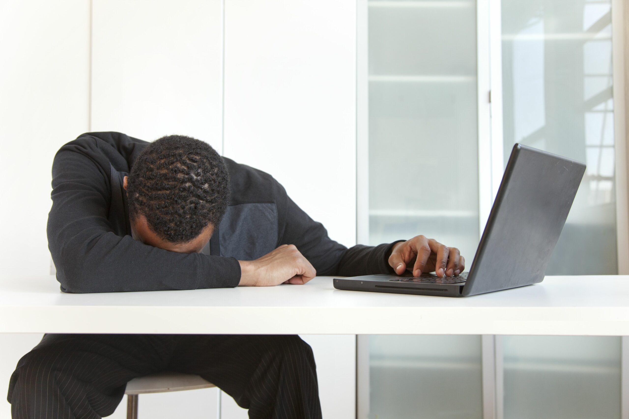 tired black businessman sleeping near laptop 145062352 5a318d219e94270037fa65b2 scaled